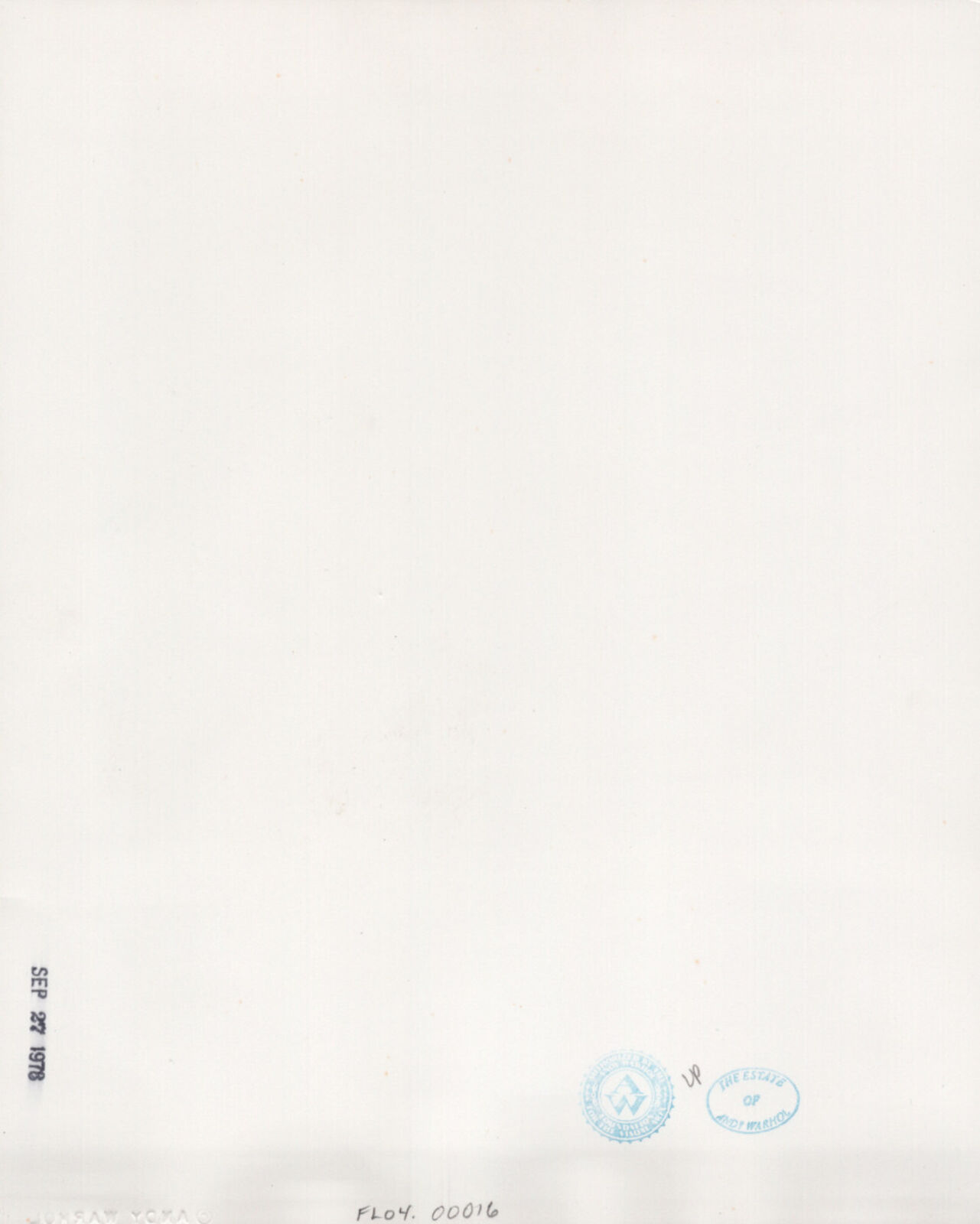 A black and white photo of a woman smiling at the camera.