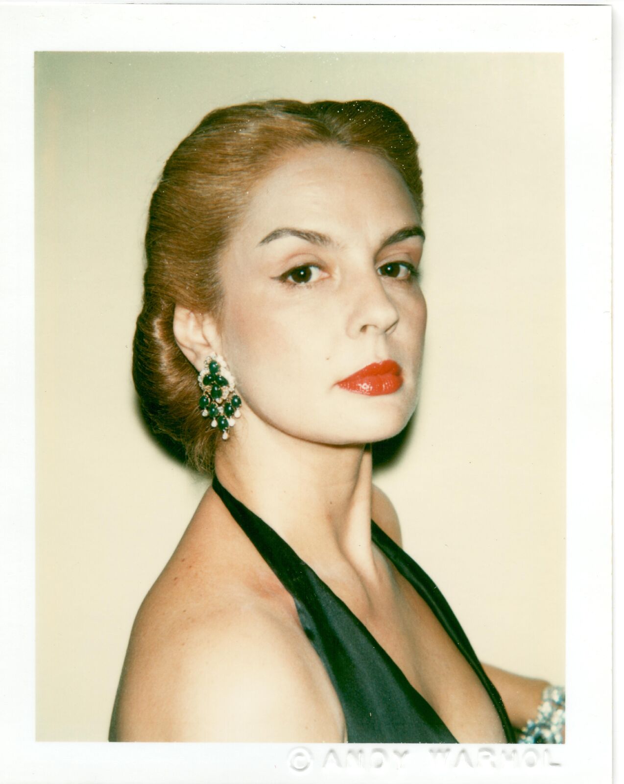 A woman in a black dress with red lipstick.