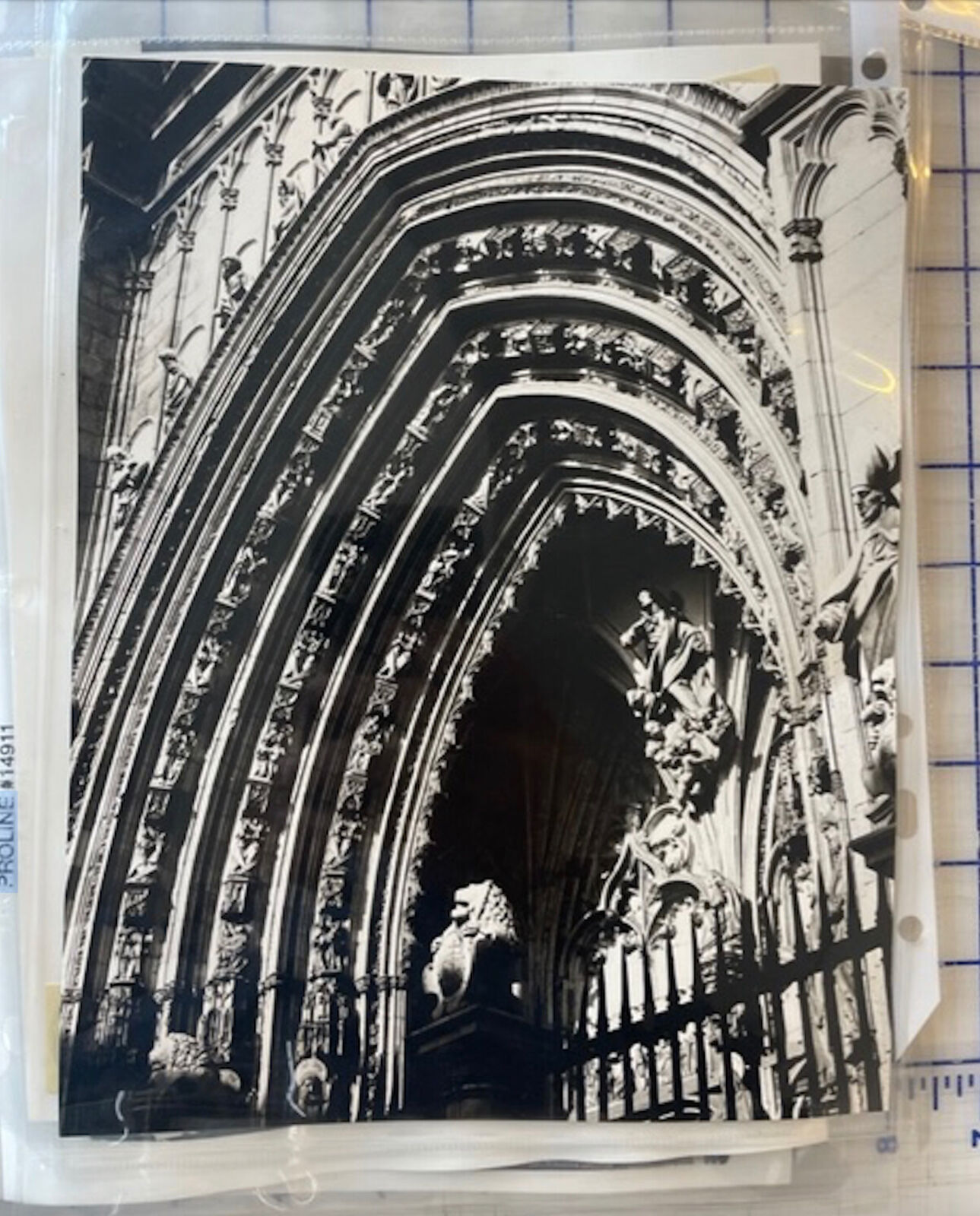 A black and white photo of an ornate archway in a church.