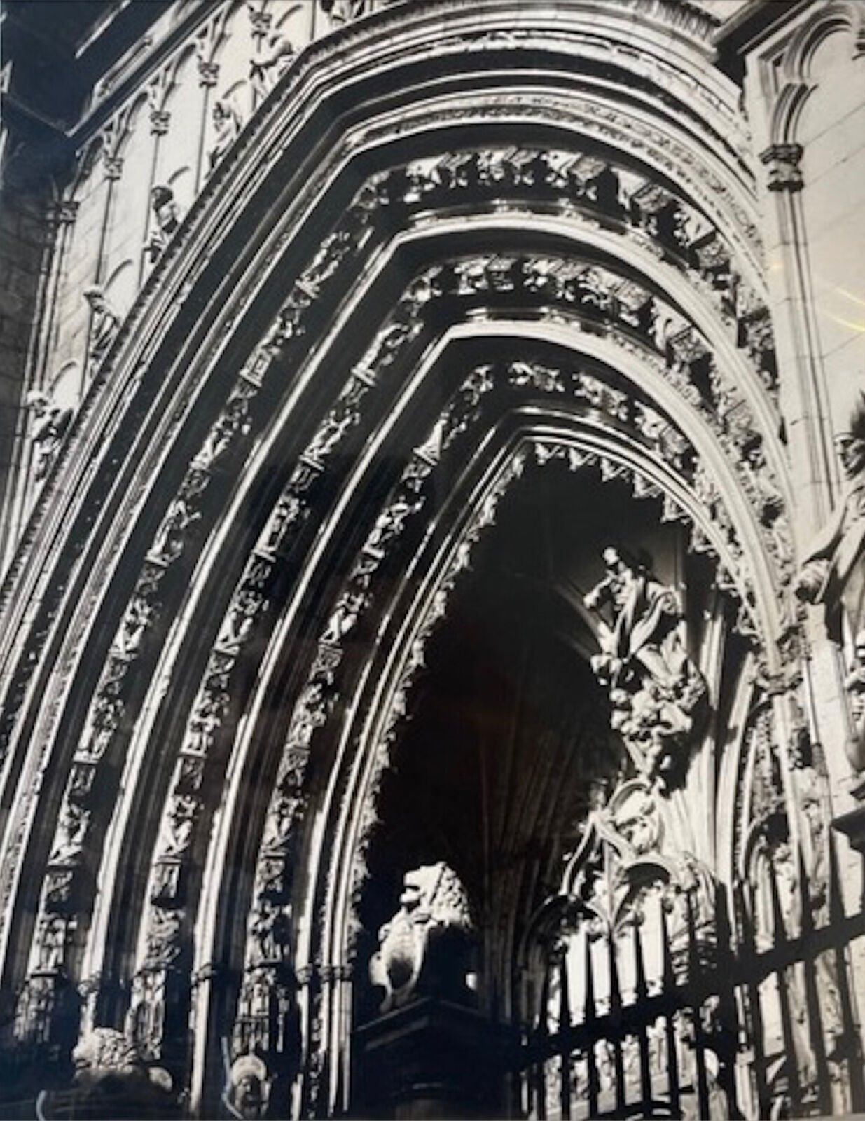 A black and white photo of an ornate archway in a church.