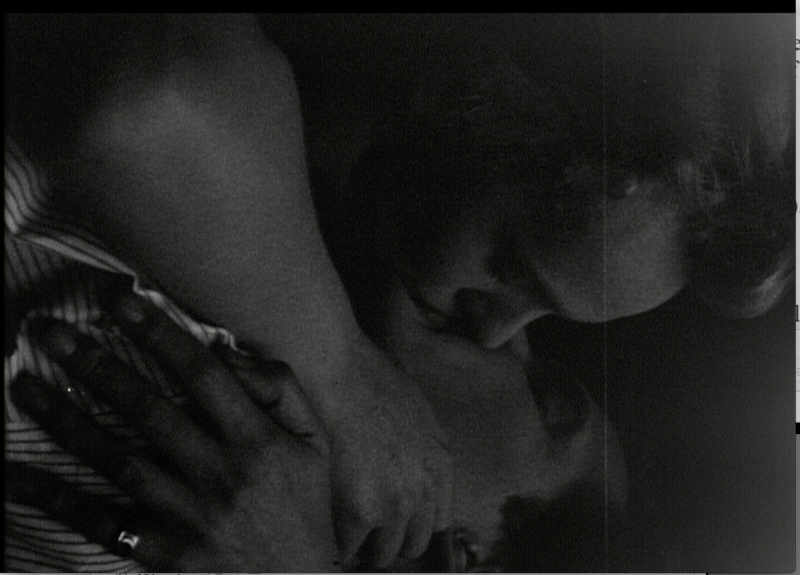 A black and white photo of a woman holding a baby.