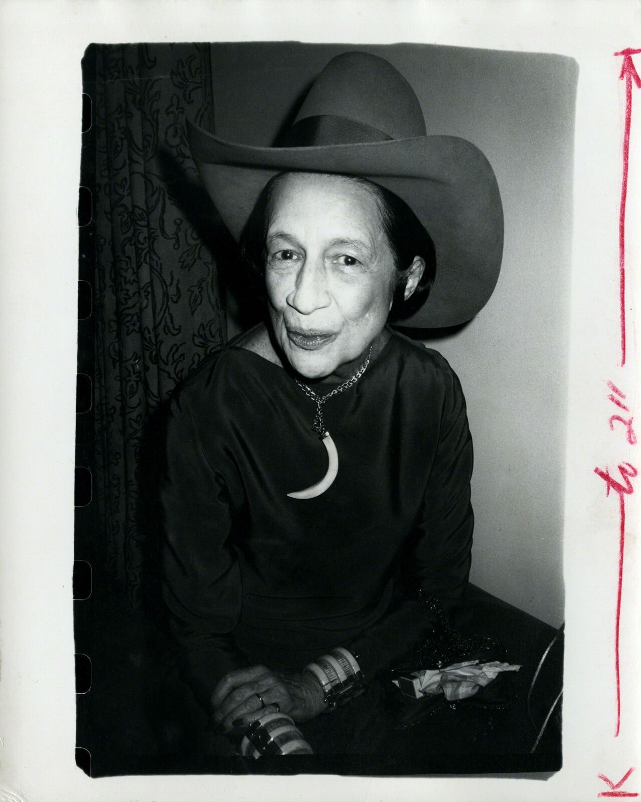 A black and white photo of a woman wearing a cowboy hat.