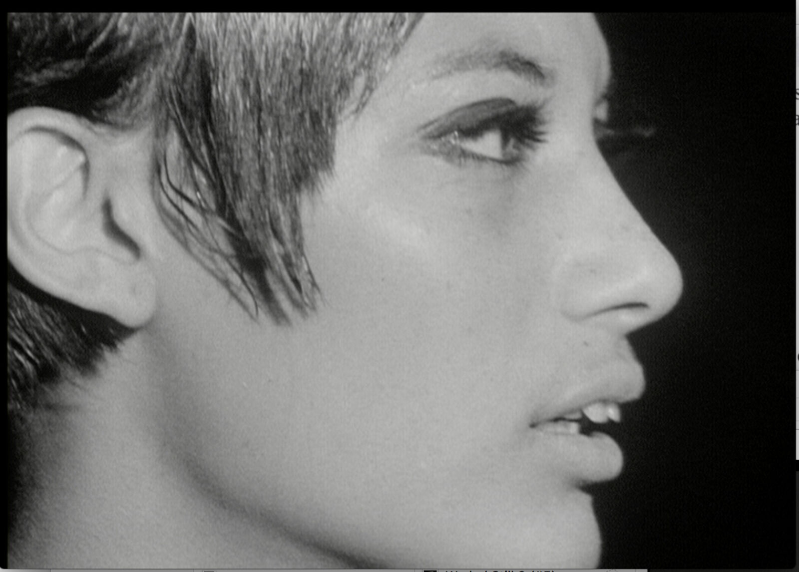 A black and white photo of a woman's face.