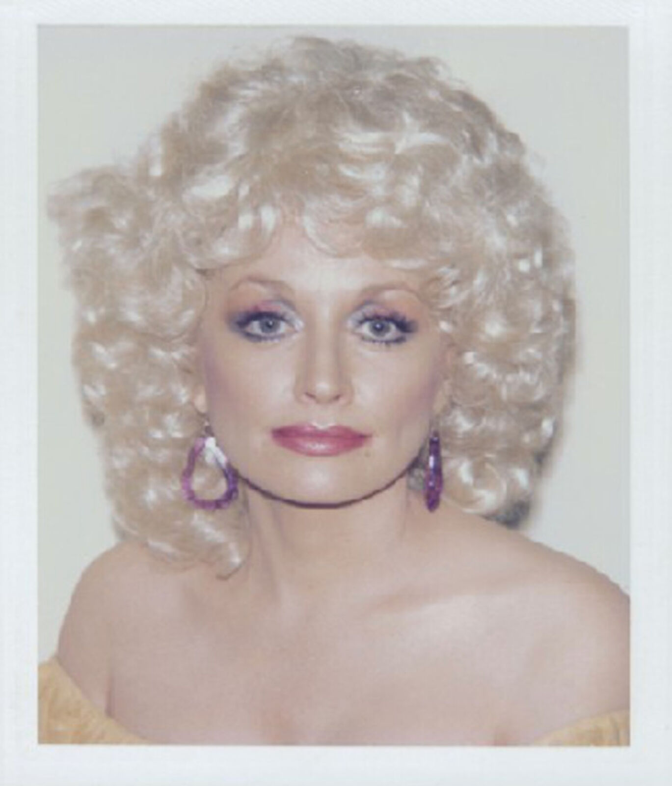 A polaroid photo of a woman with blonde hair.