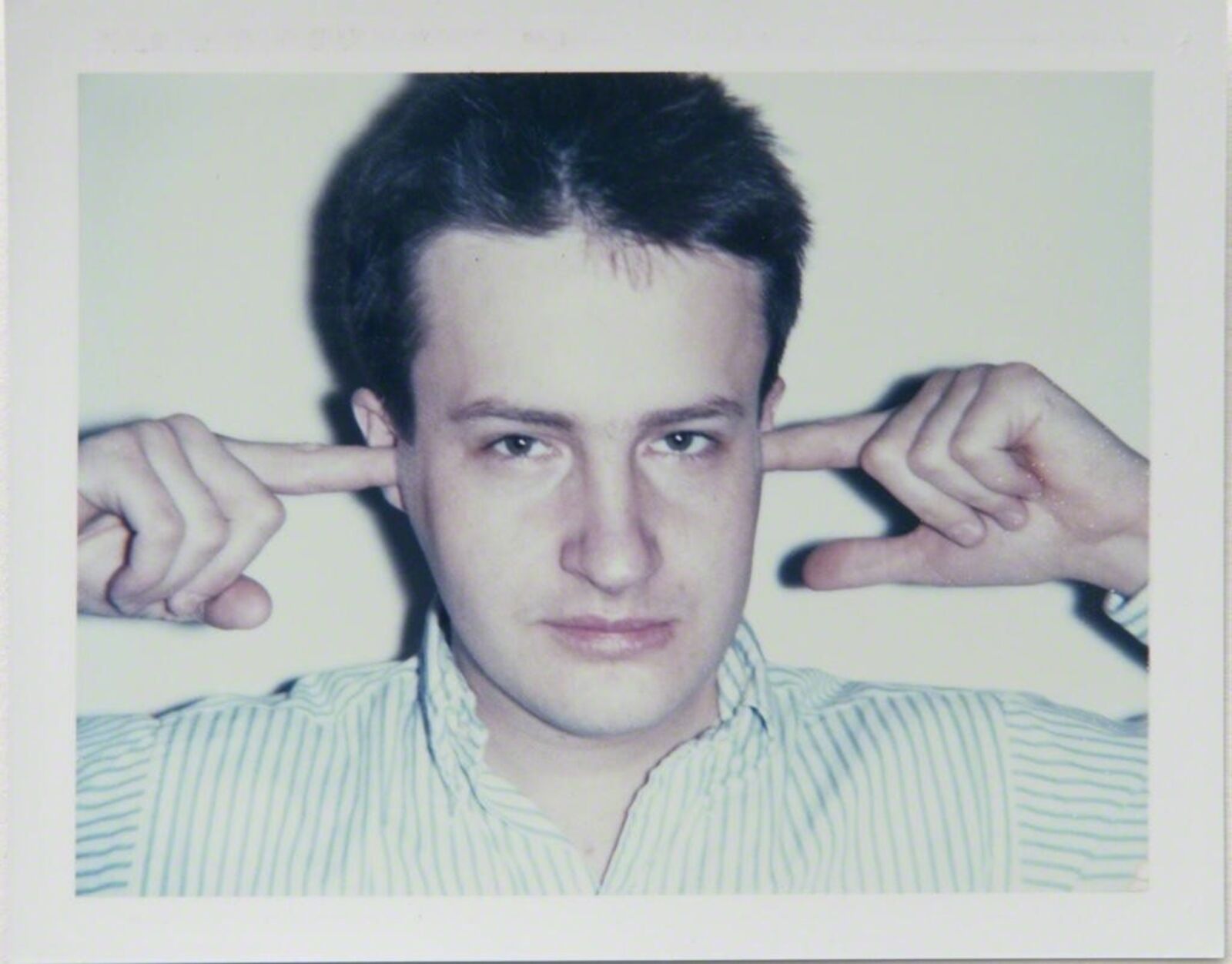 three polaroids of a man with his hands on his head