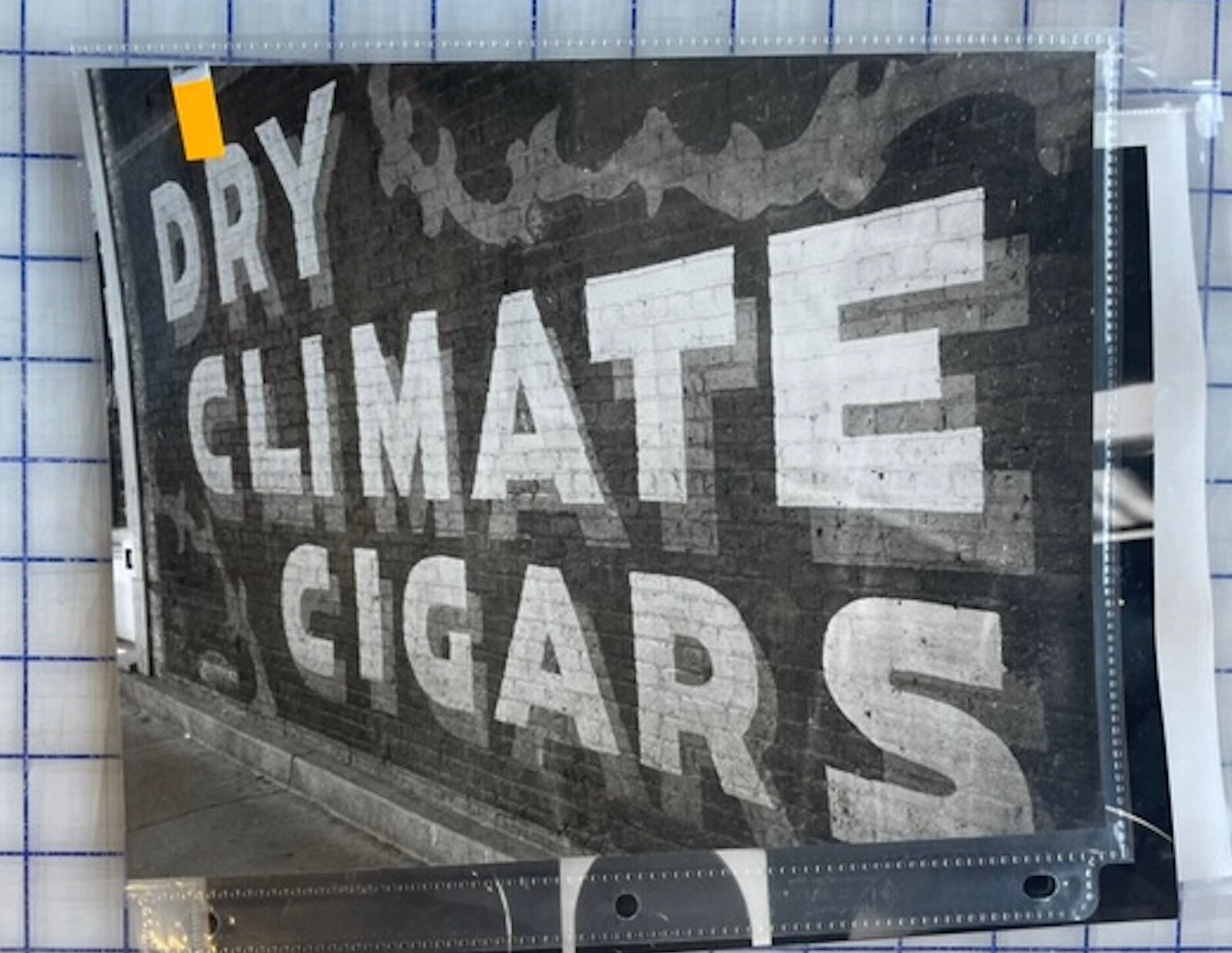A sign on the side of a building that says Dry Climate Cigars.