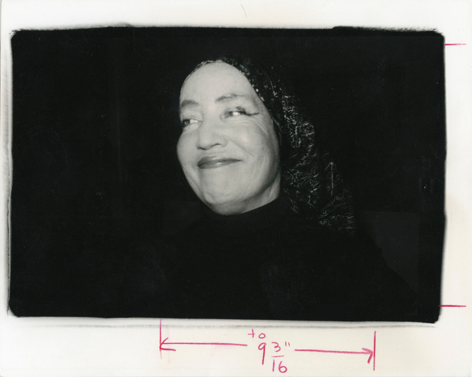 A black and white photo of a woman smiling.