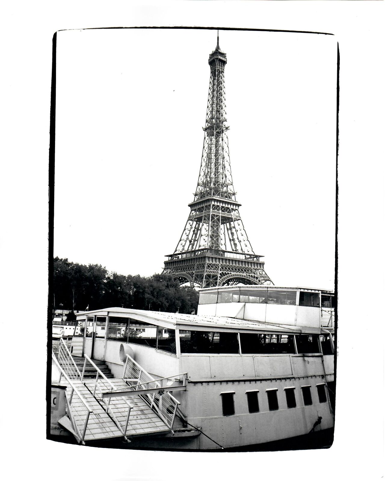A black and white photo of the Eiffel Tower.