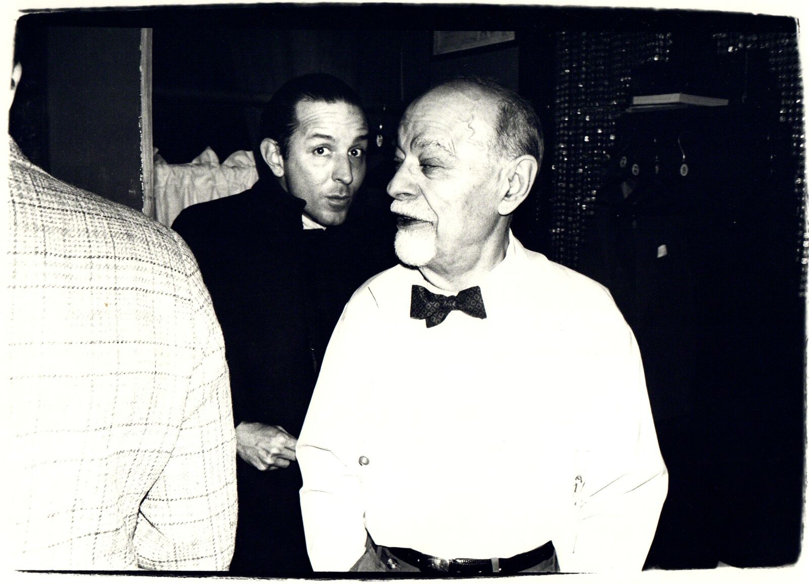 A black and white photo of two men standing next to each other.