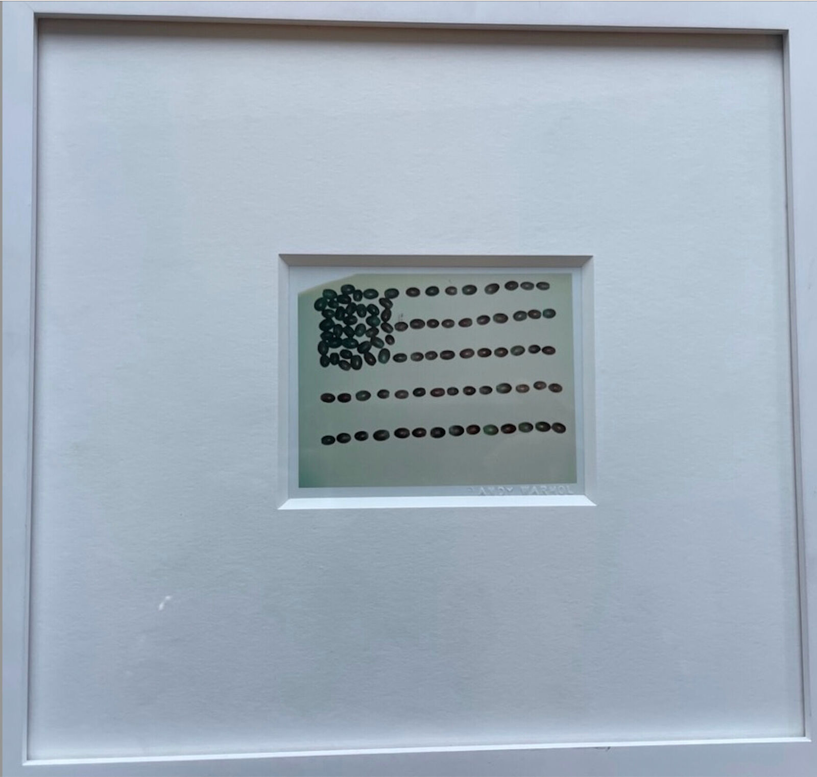 A picture of a white frame with a picture of an American flag on it.