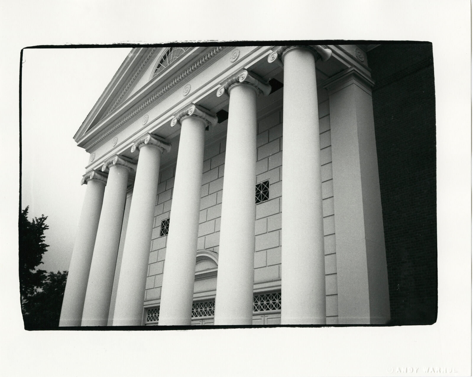 A black and white photo of a building with columns.