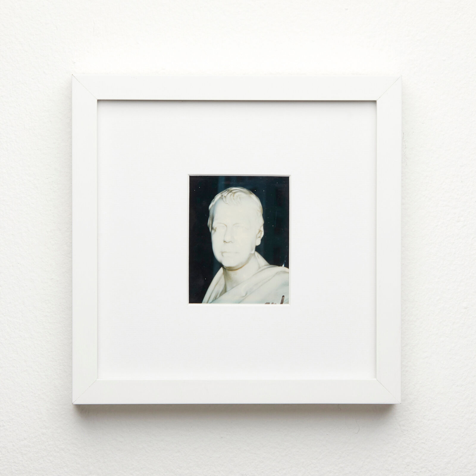 A black and white photo of a man in a white frame.