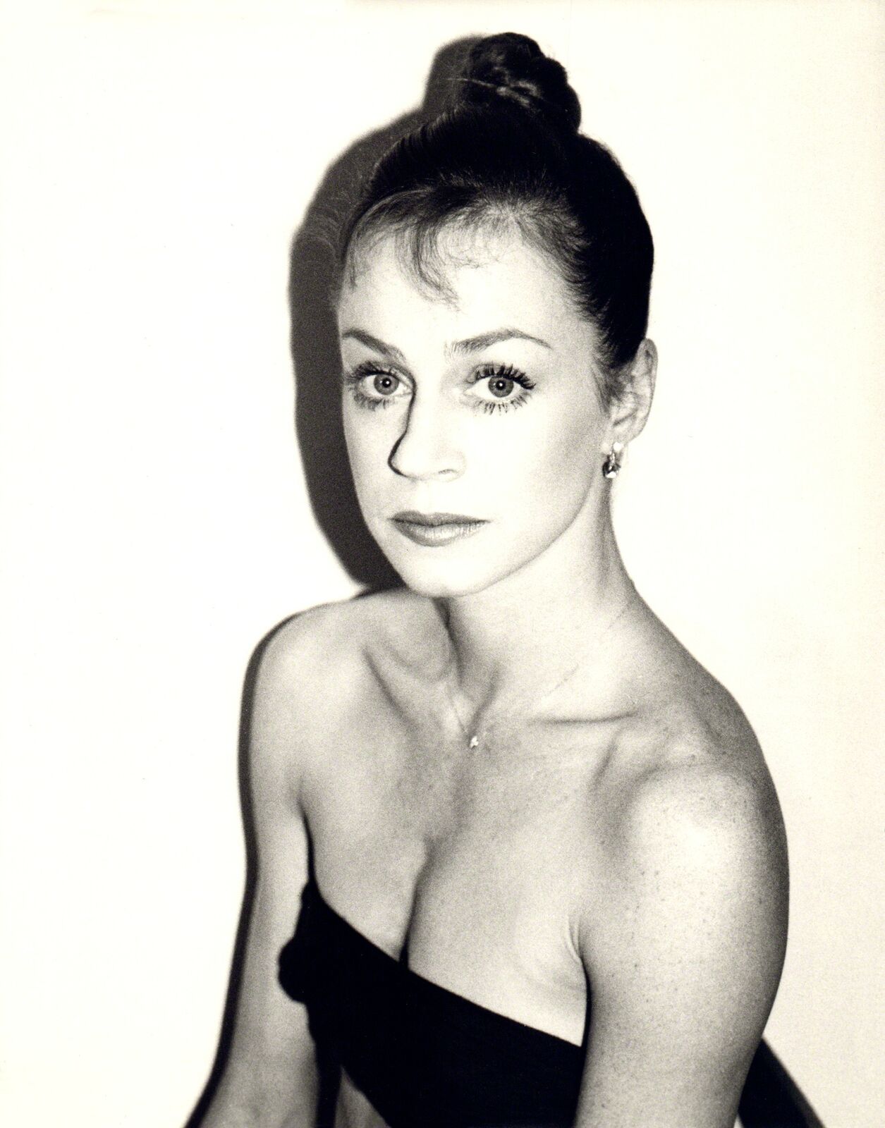 A black and white photo of a woman in a dress.