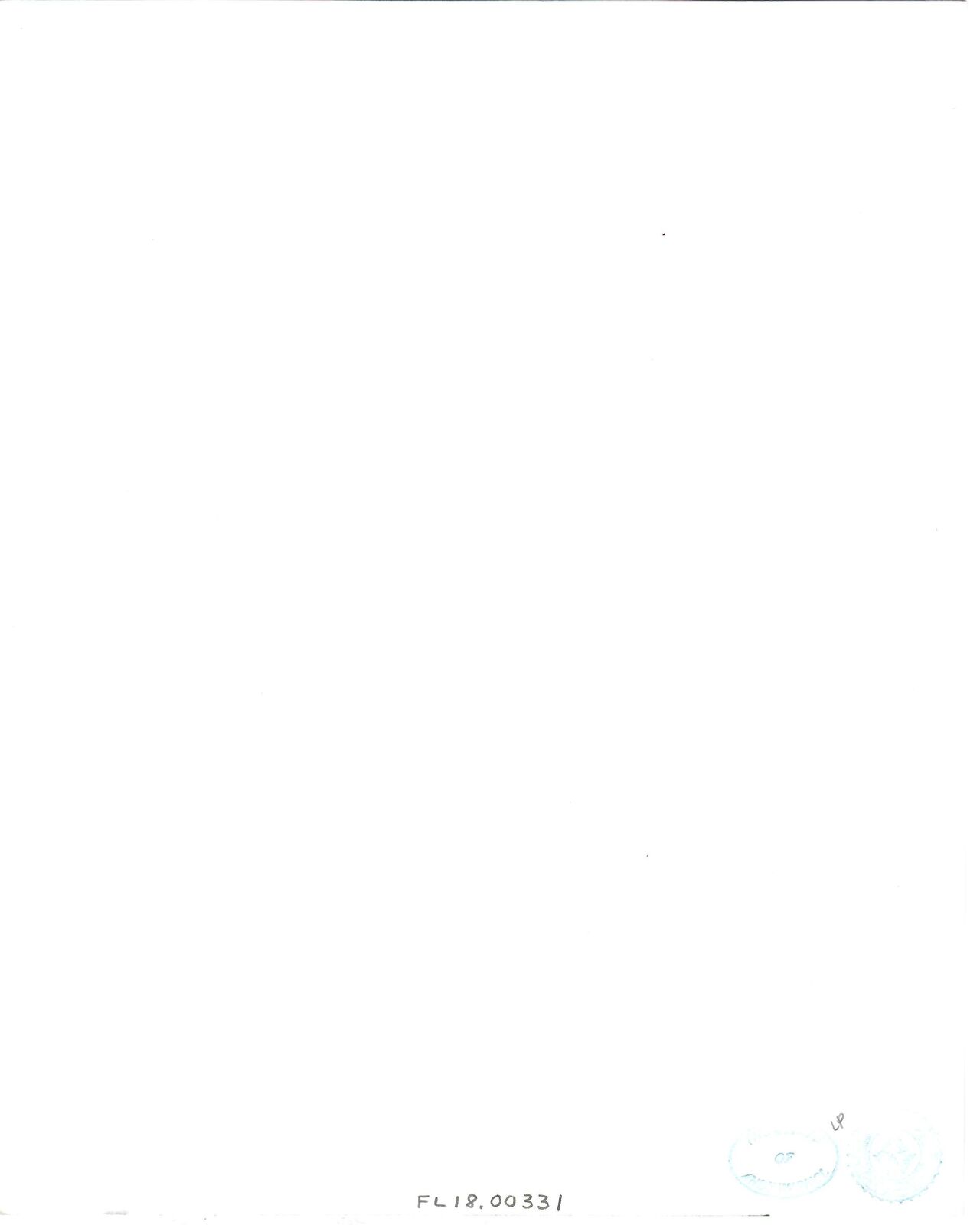 A black and white photo of a desk with a telephone on it.