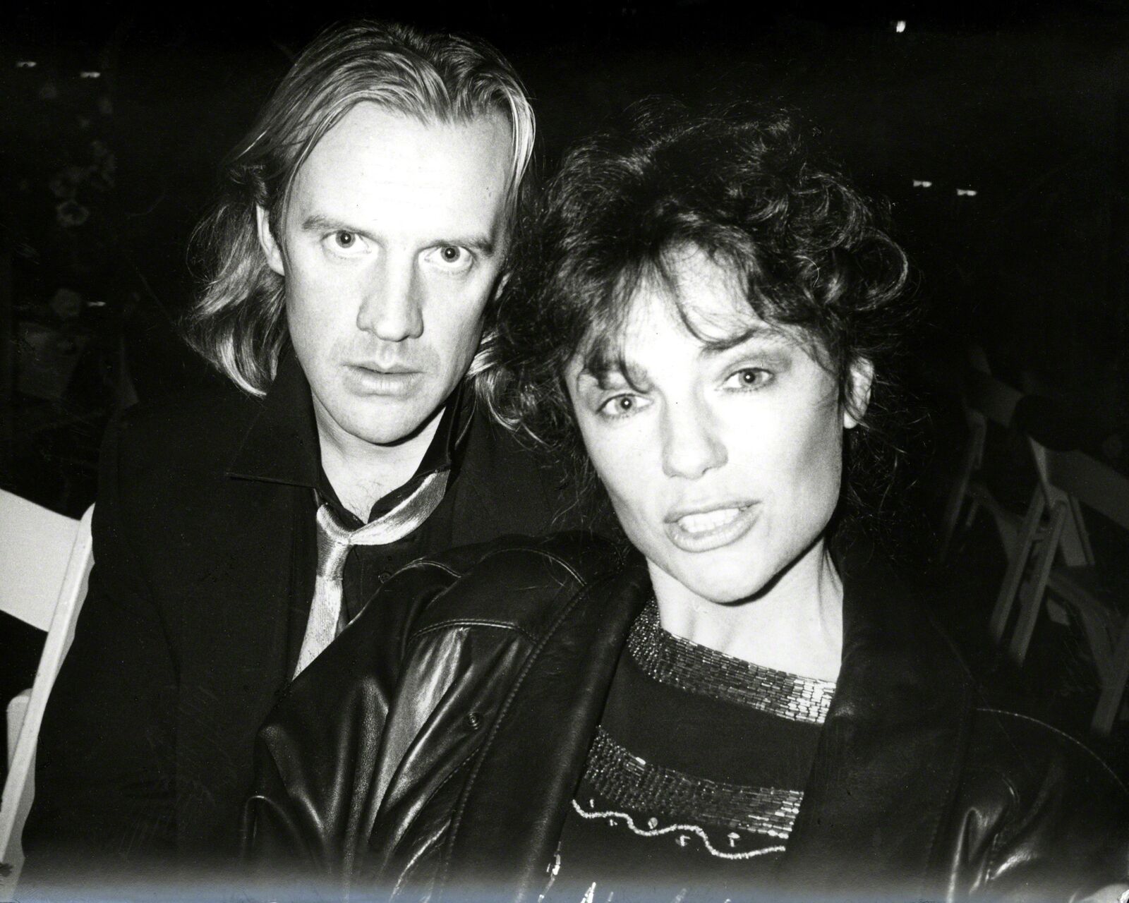 A man and a woman sitting next to each other.