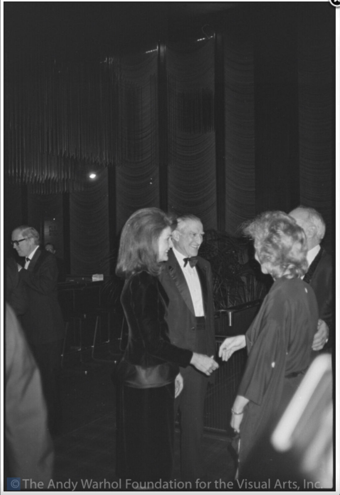 A black and white photo of a man and woman shaking hands.