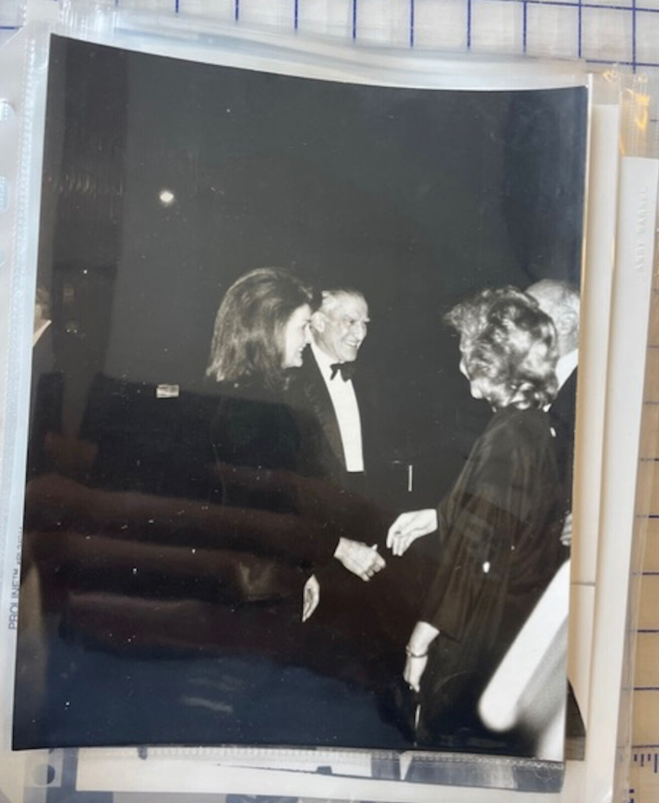 A black and white photo of a man and woman shaking hands.