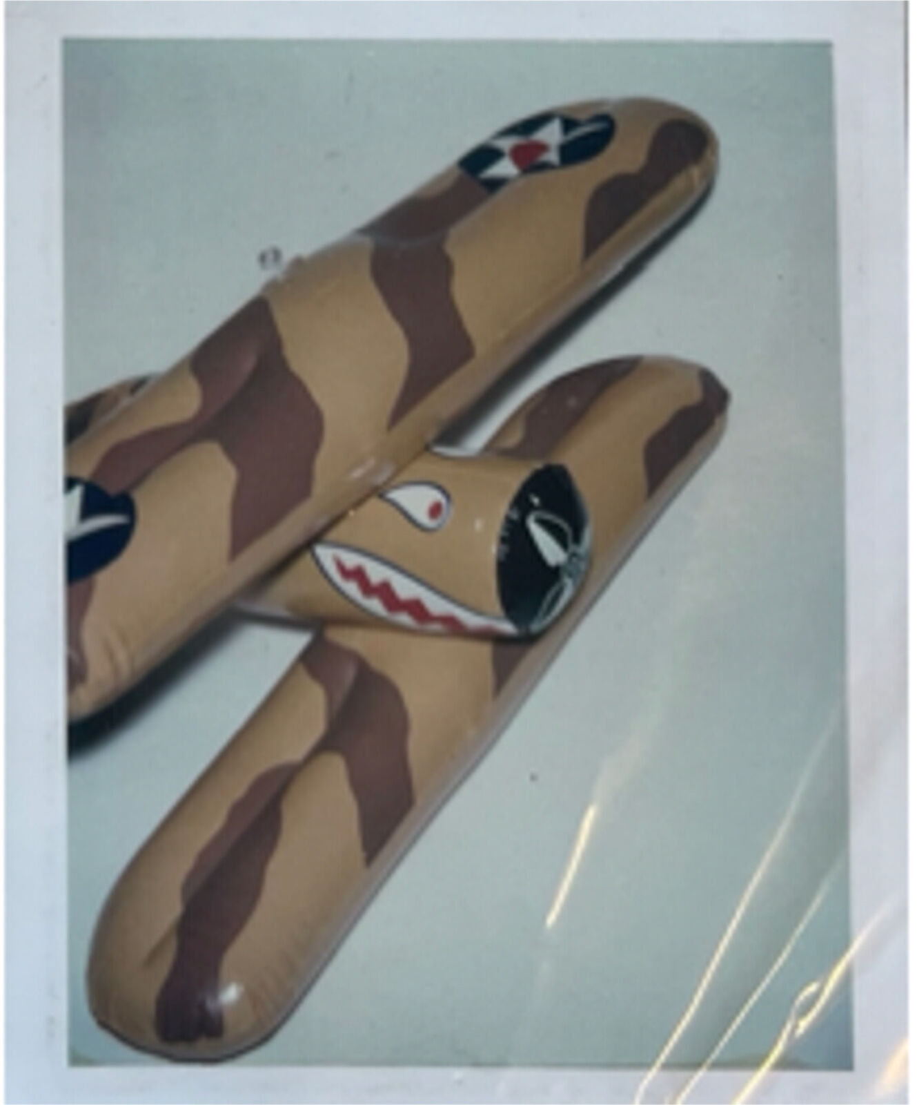 A picture of a toy airplane with a camouflage pattern on it.