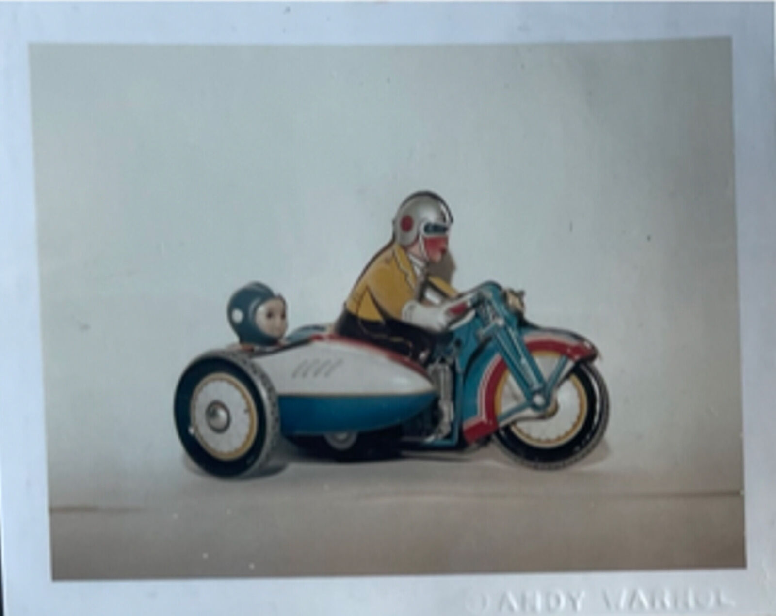 A picture of a man riding a motorcycle with a child on it.