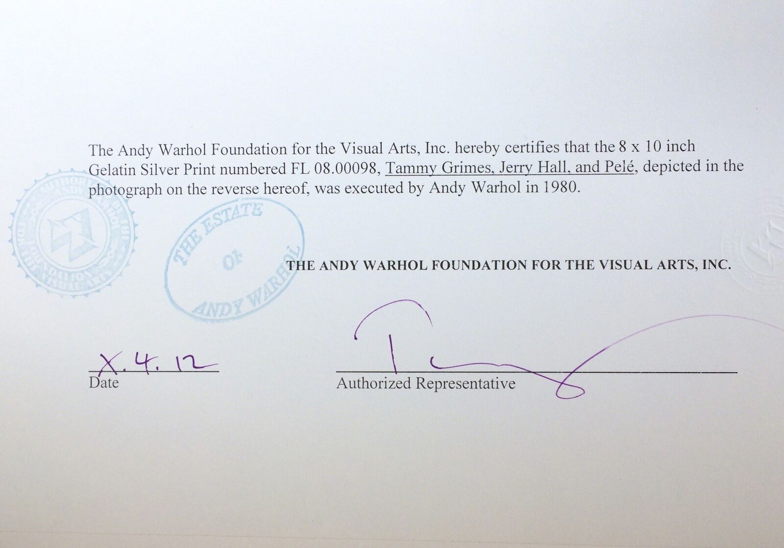 A black and white photo of two women and a man sitting at a table.