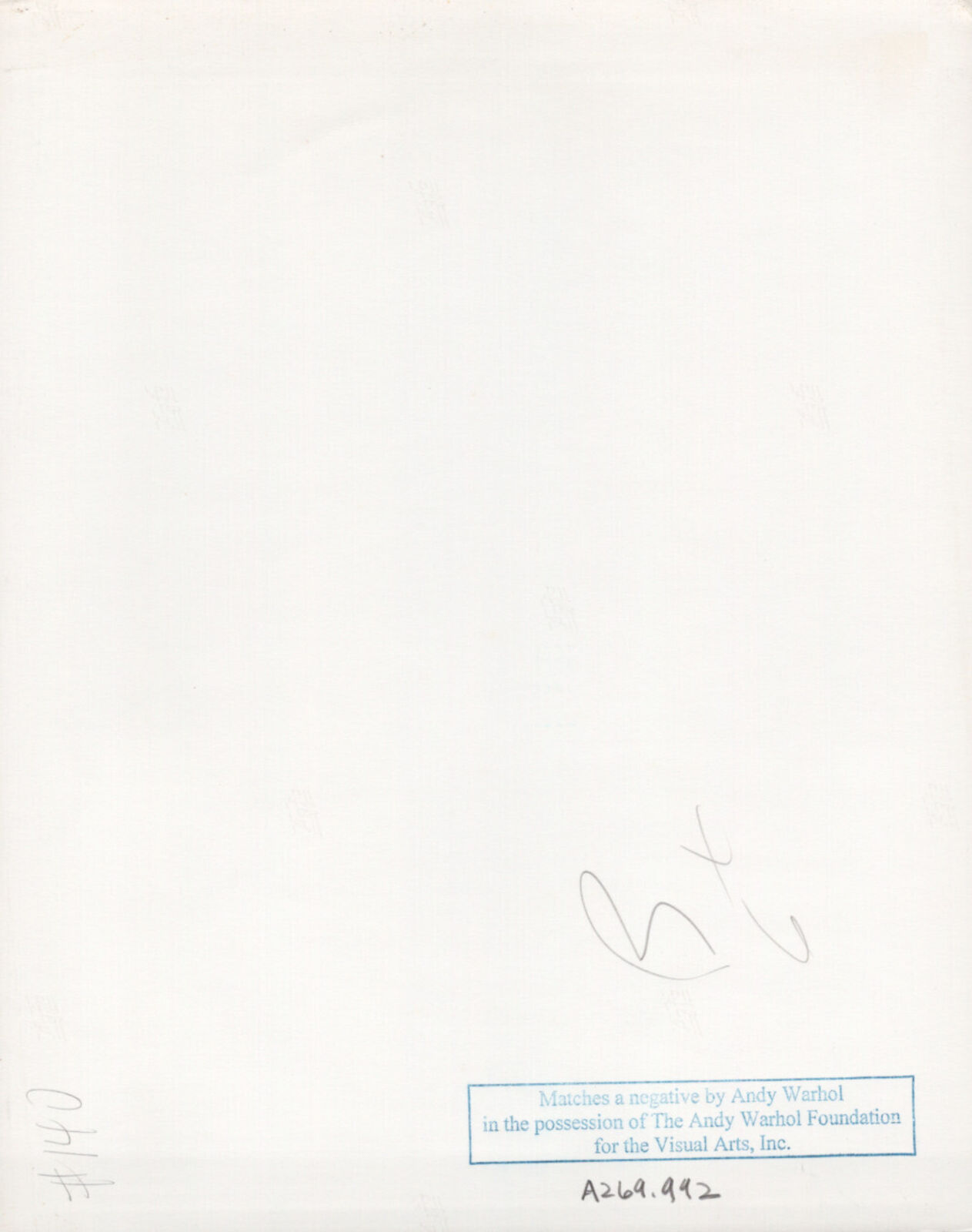 A group of people standing under an umbrella in the rain.