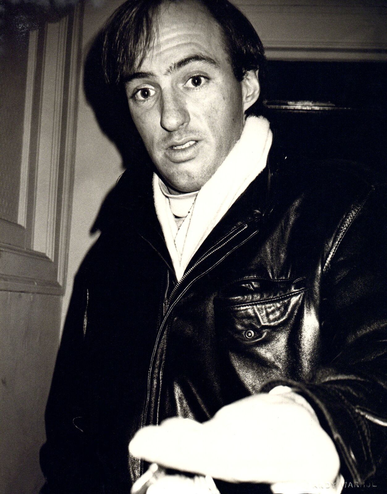 A black and white photo of a man in a leather jacket.