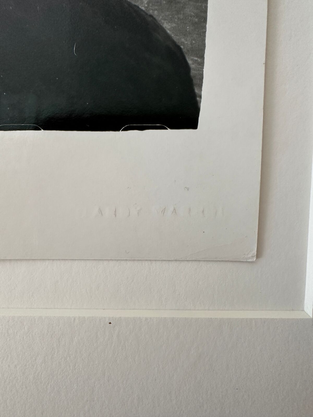 A man standing on top of a rock in the ocean.