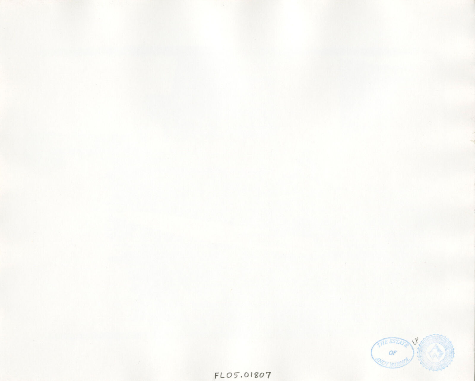 A man kneeling on a surfboard in front of a house.