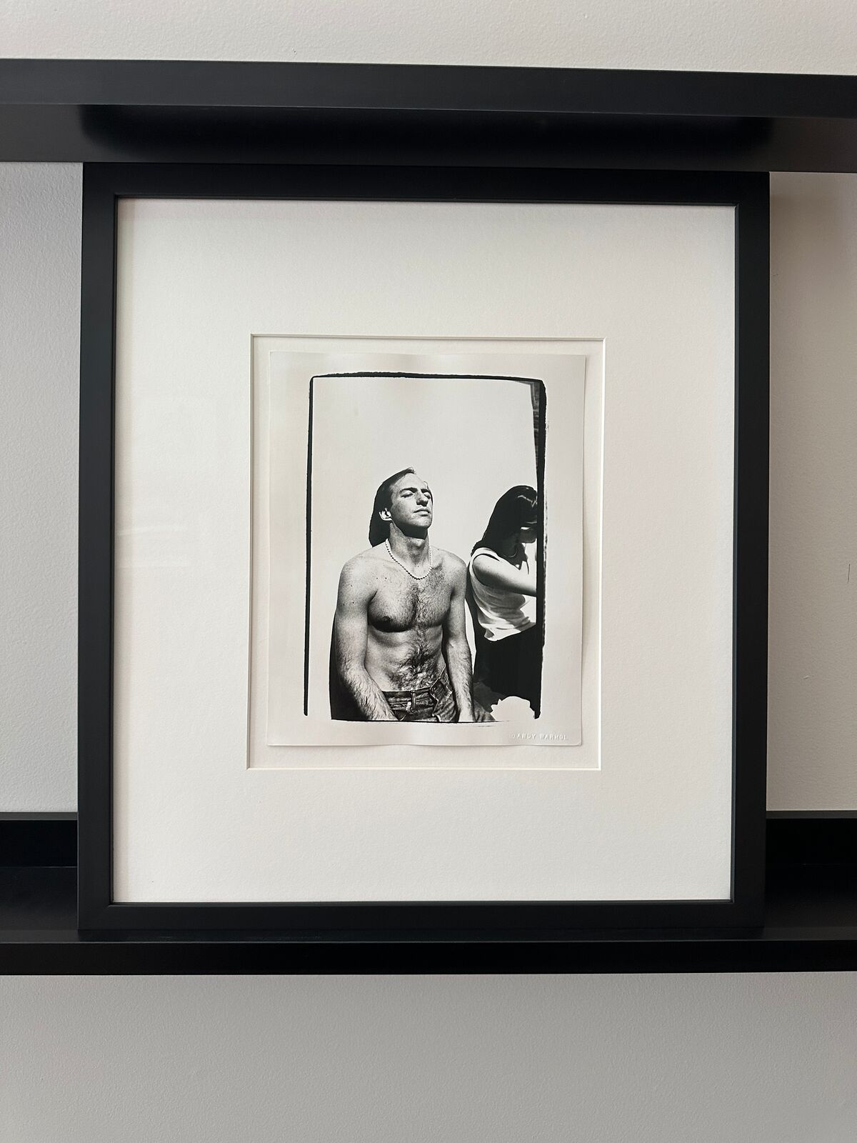 A shirtless man standing next to a woman.