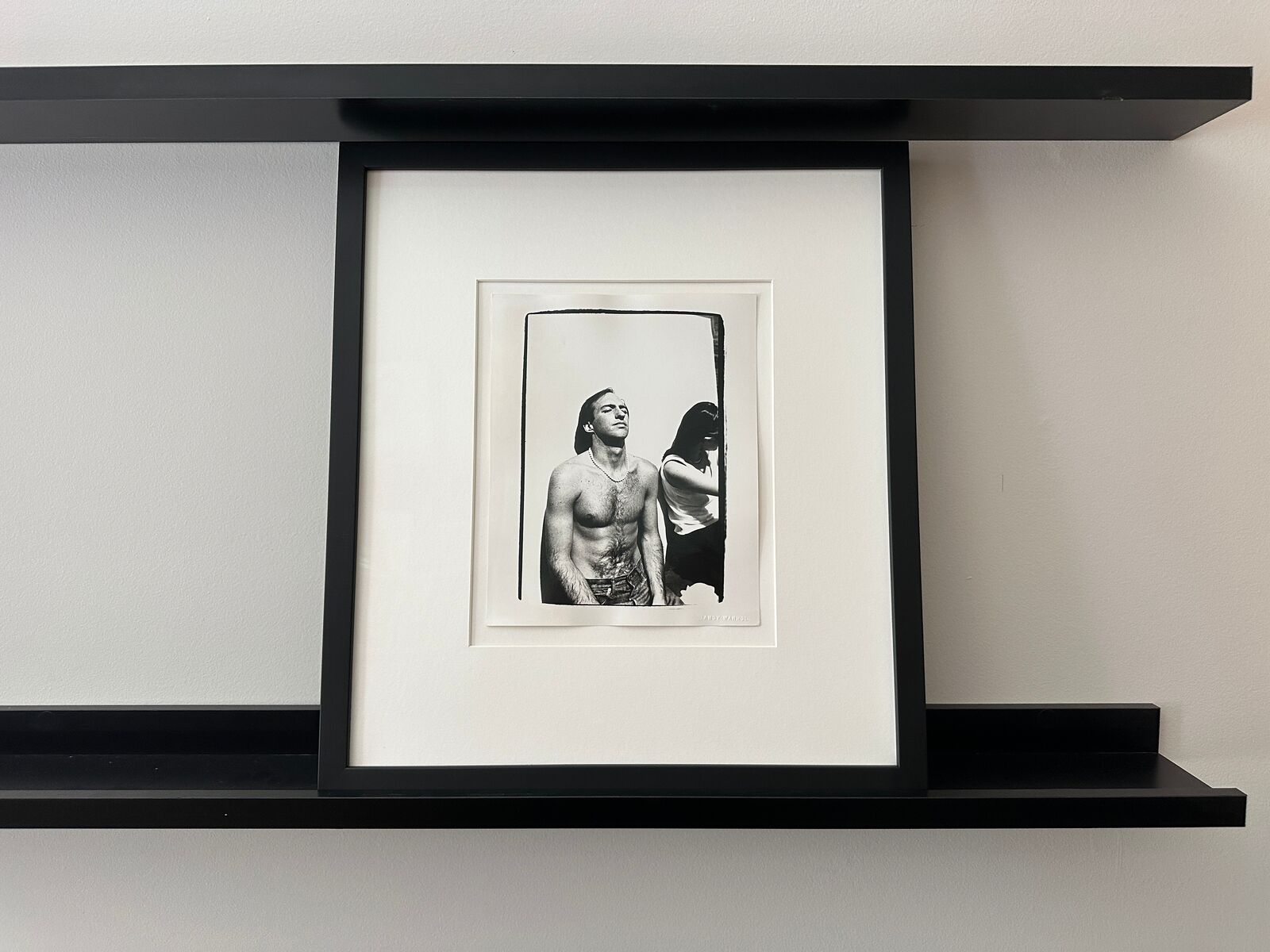 A shirtless man standing next to a woman.