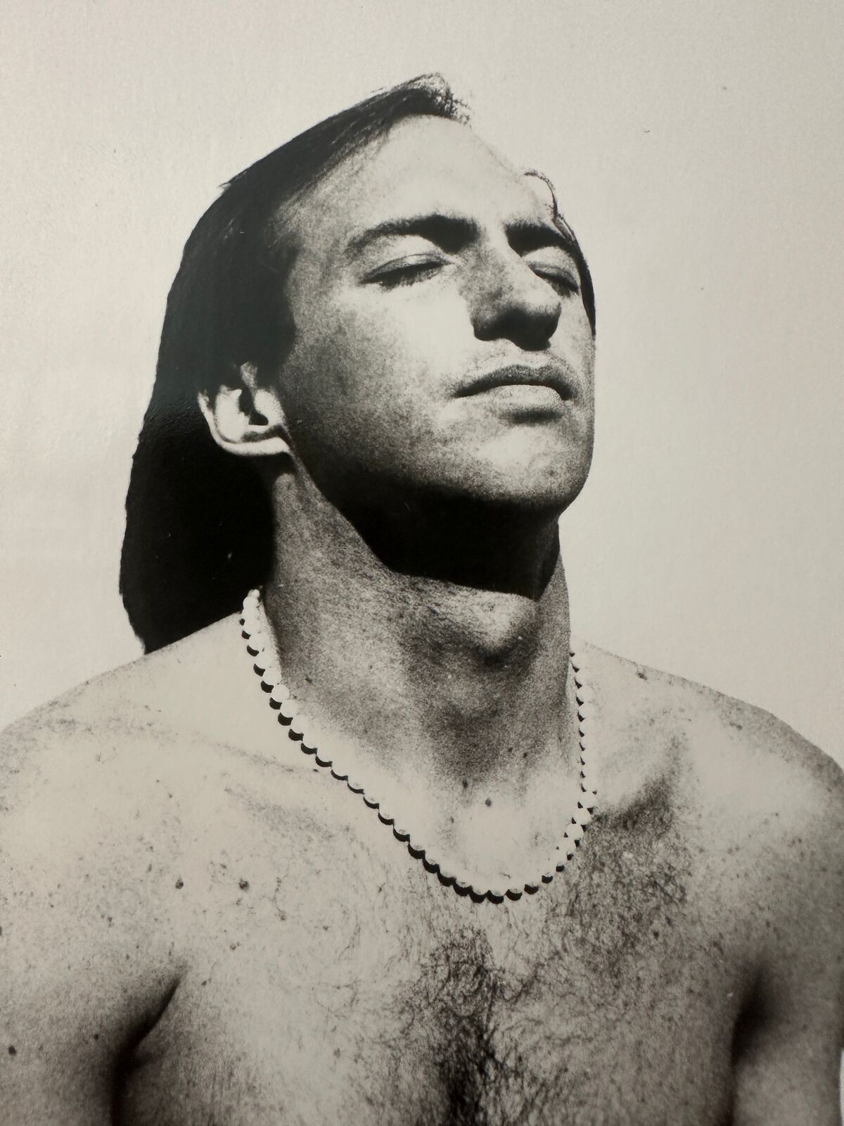 A shirtless man standing next to a woman.