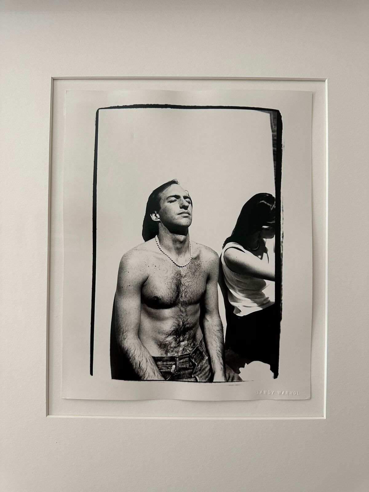 A shirtless man standing next to a woman.