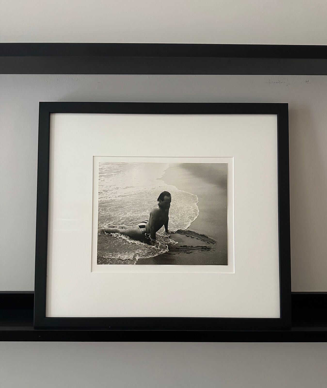 A man in a bathing suit is playing in the water.