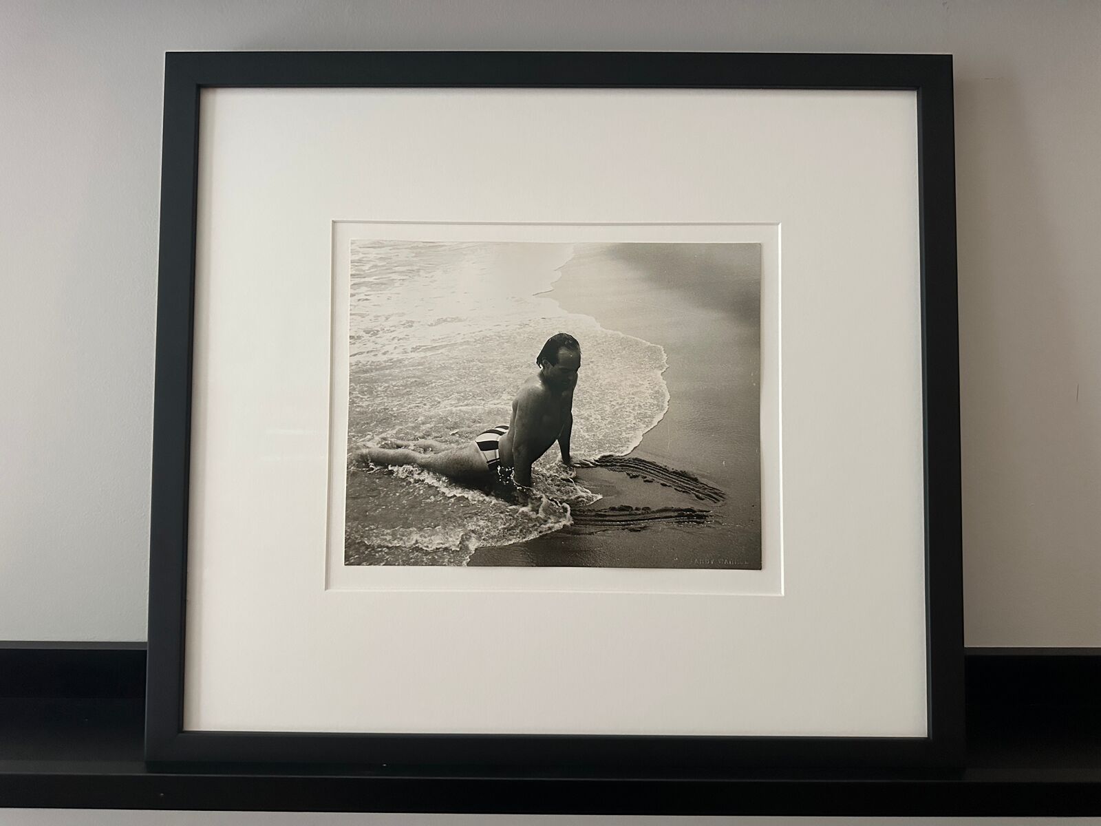 A man in a bathing suit is playing in the water.