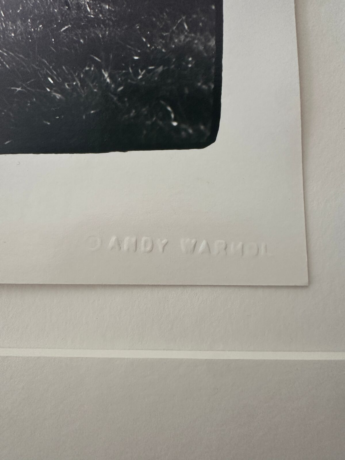 A black and white photo of a man doing a handstand in a park.