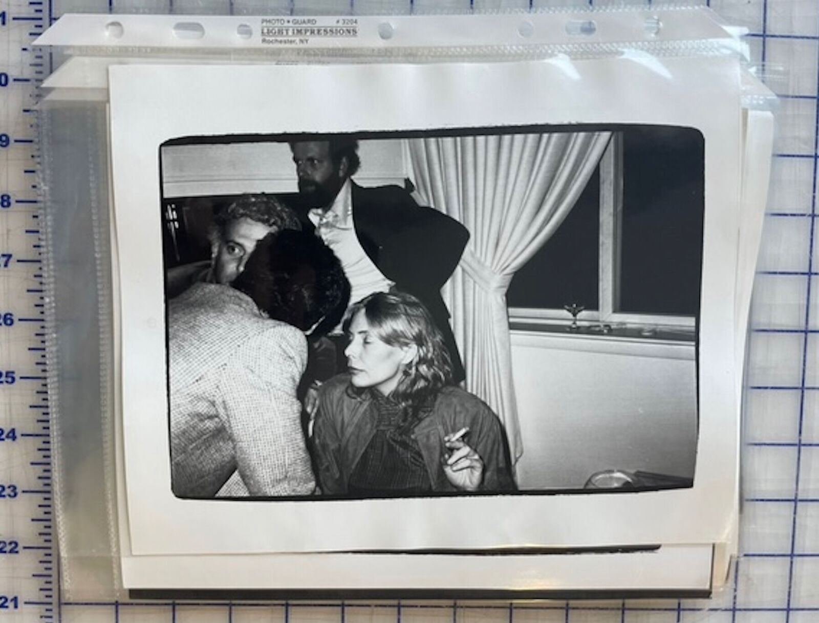 A black and white photo of a man and a woman in a room.