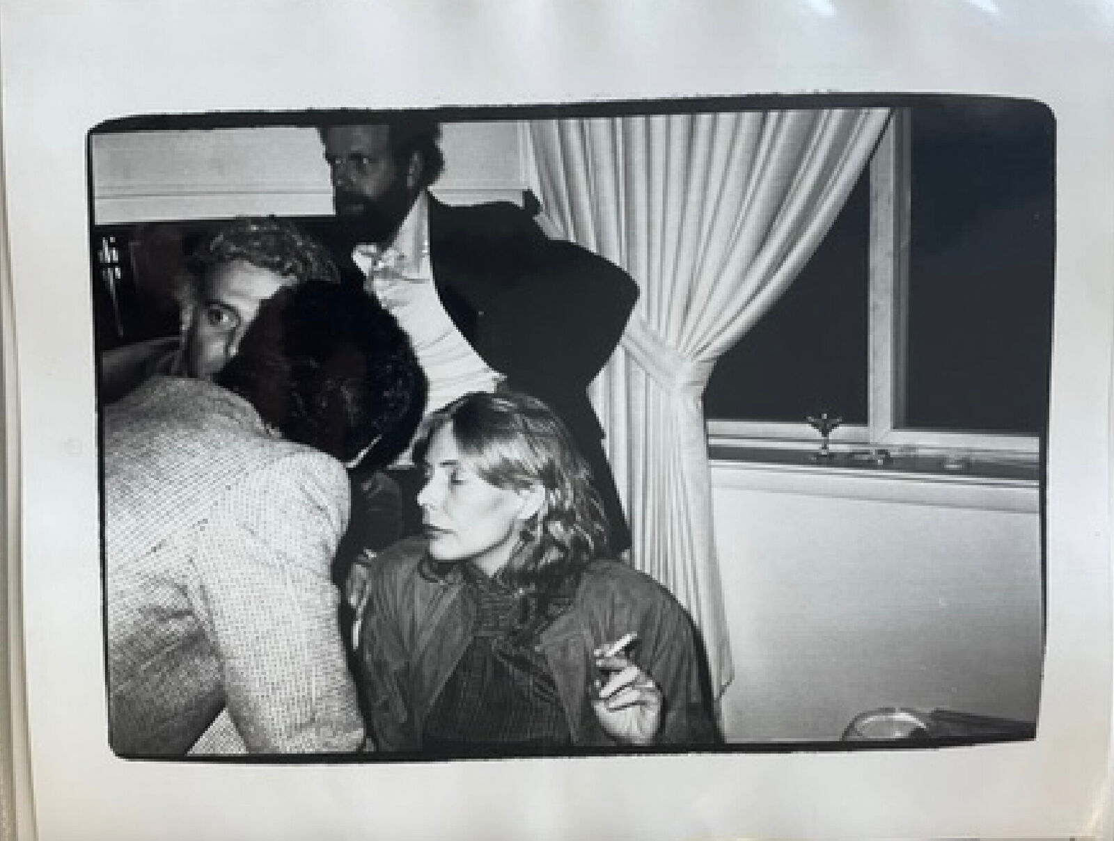 A black and white photo of a man and a woman in a room.