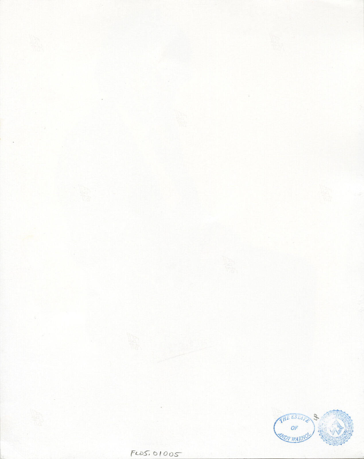 A man in a suit and tie sitting on a chair.