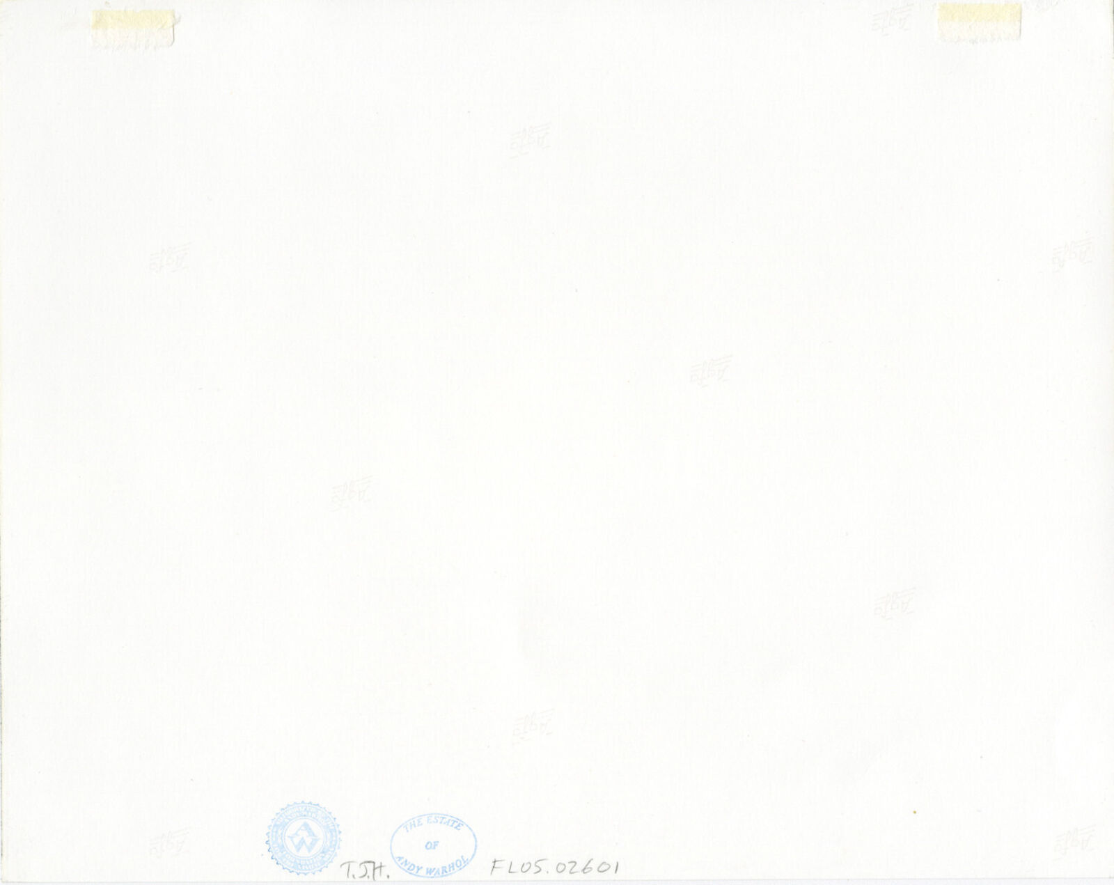 A man sitting at a table with a bottle of wine.