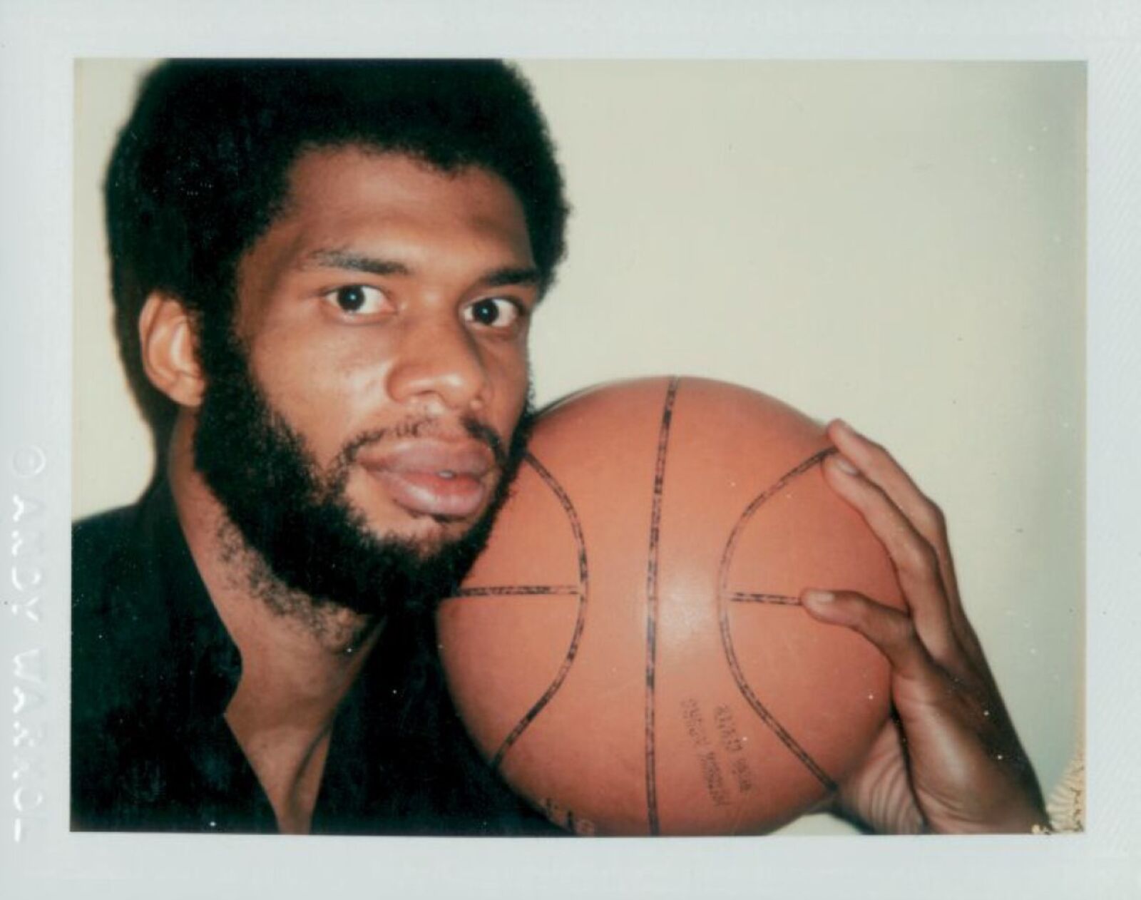 A man holding a basketball in his hands. 