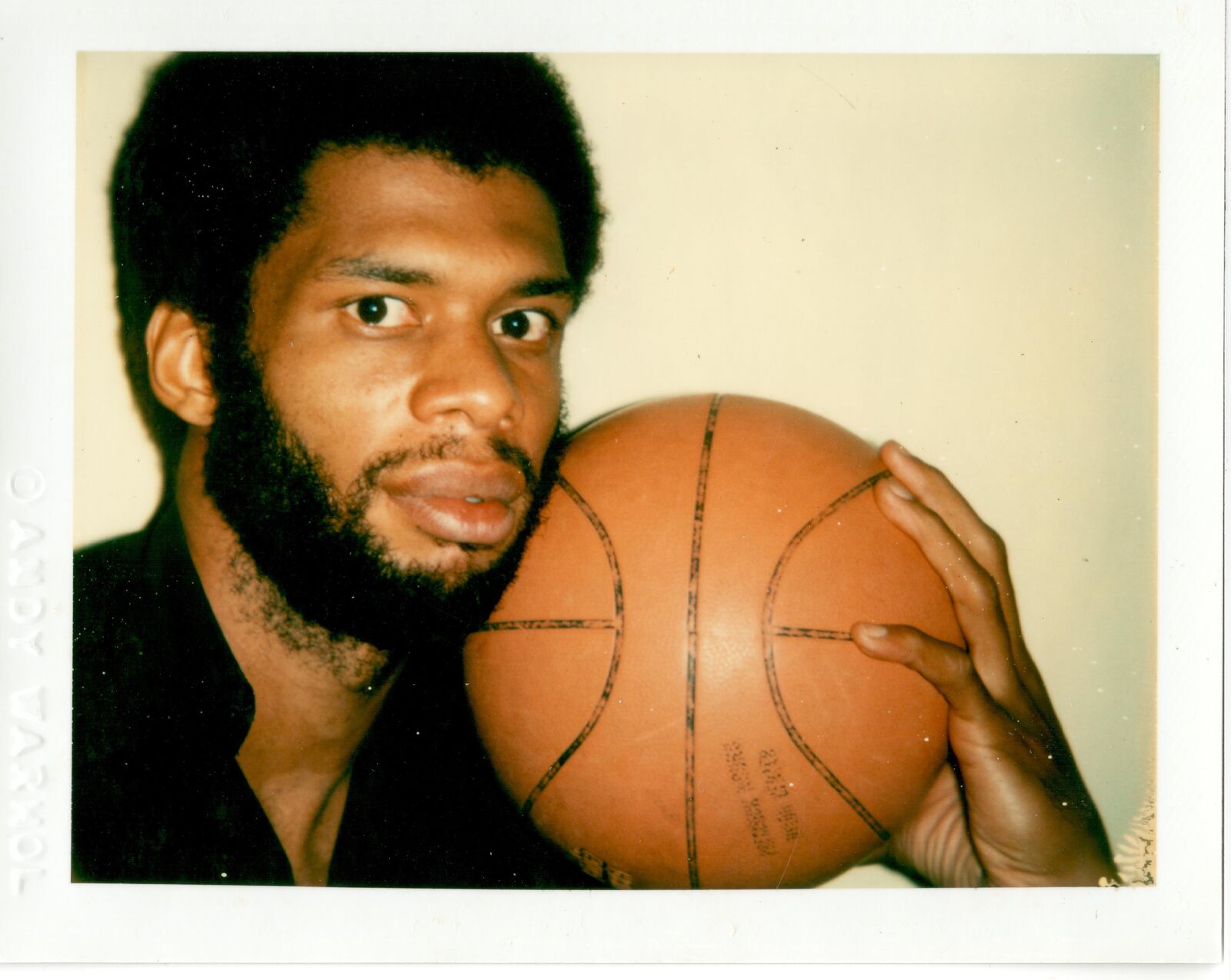 A man holding a basketball in his hands. 