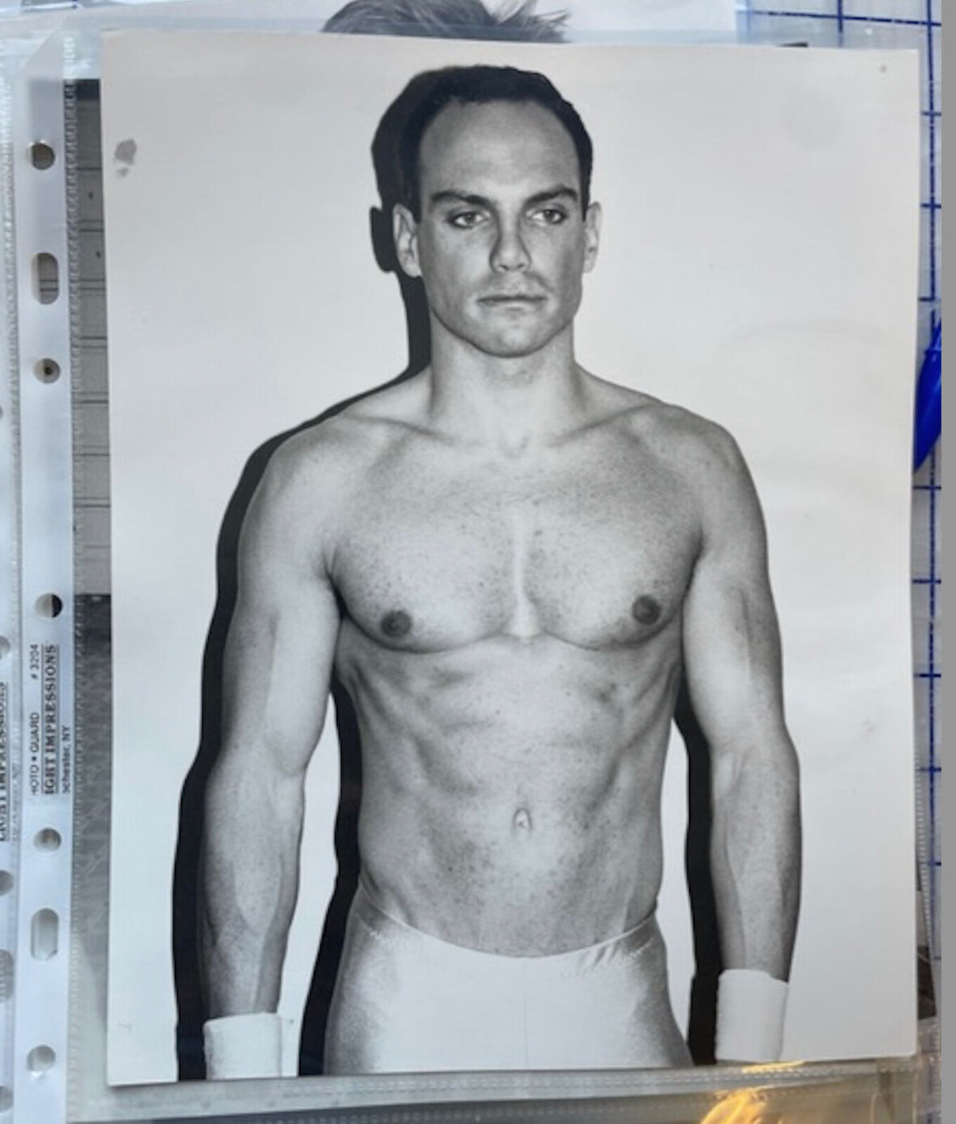 A shirtless man in a white underwear posing for a picture.