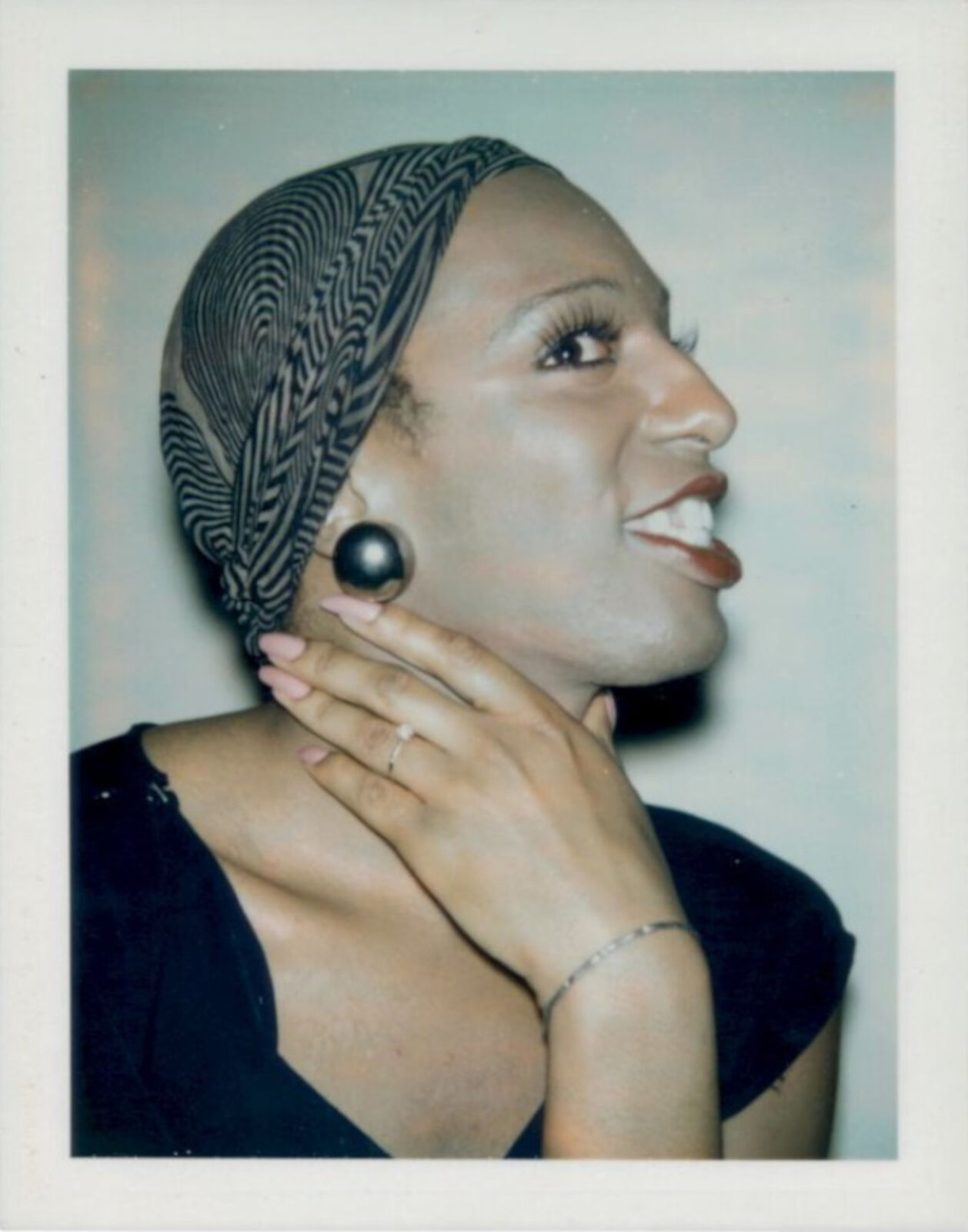 A woman wearing a headscarf and a ring on her finger.