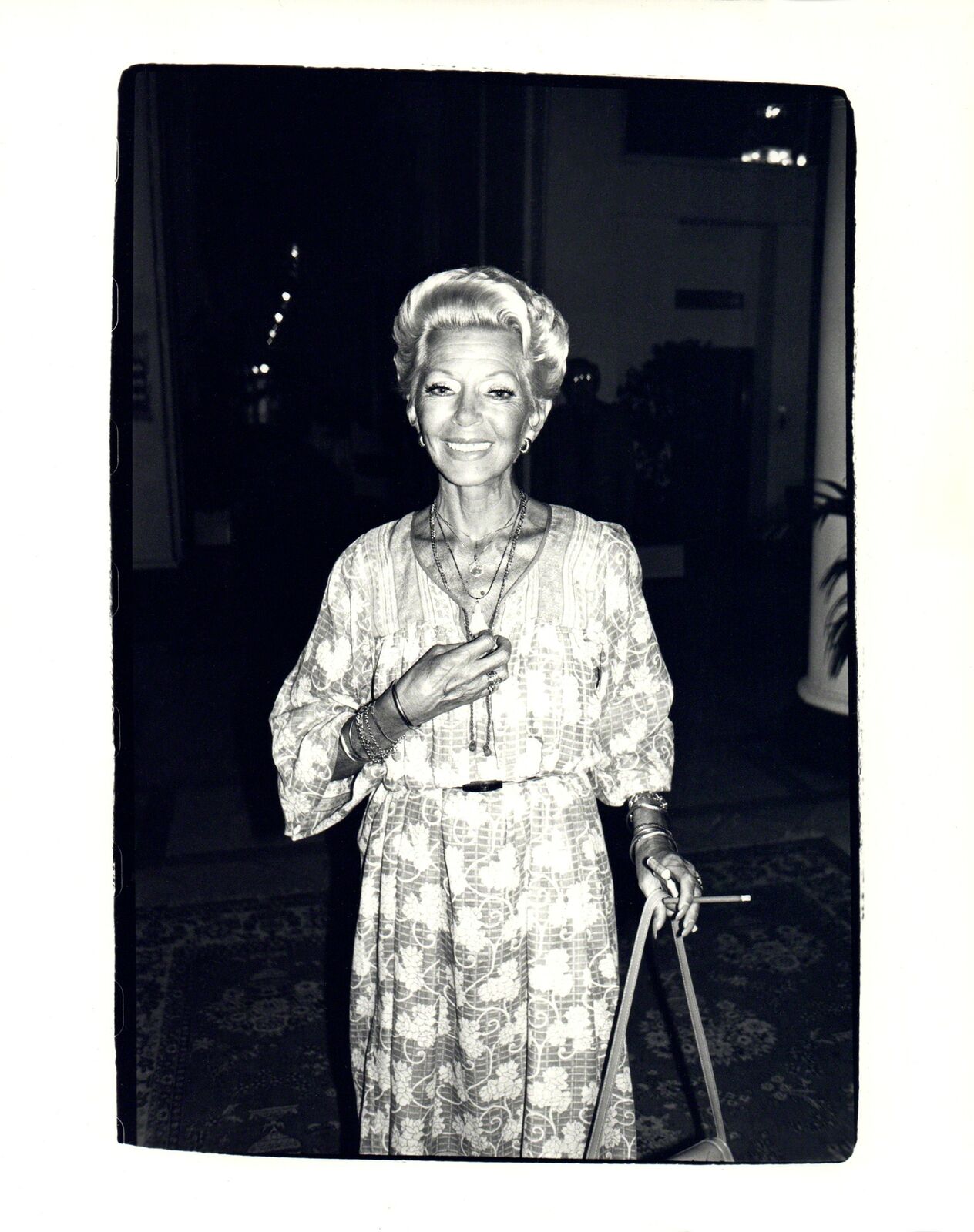 A black and white photo of a woman with a cane.