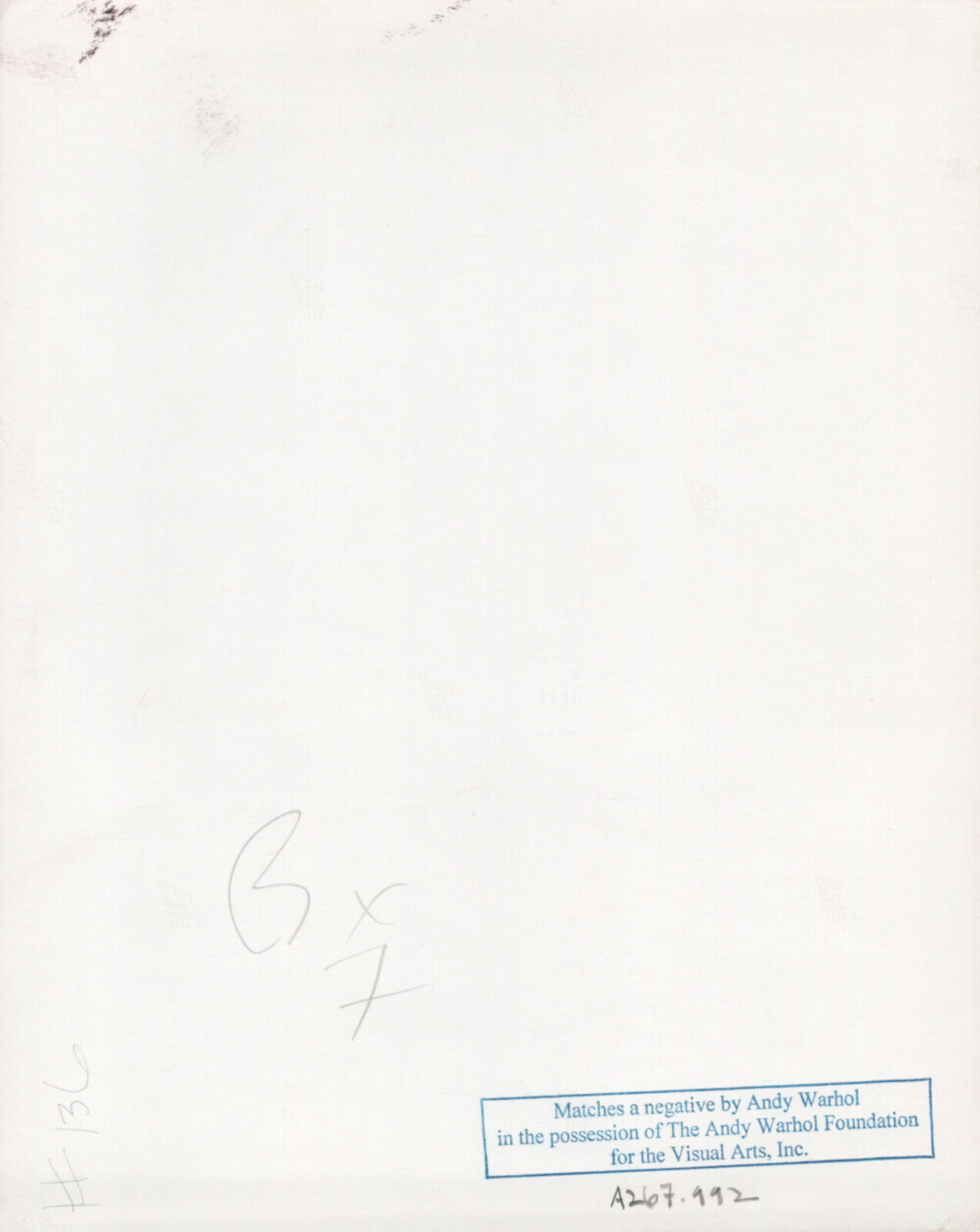 A man in a suit sitting at a table with a bowl of food.