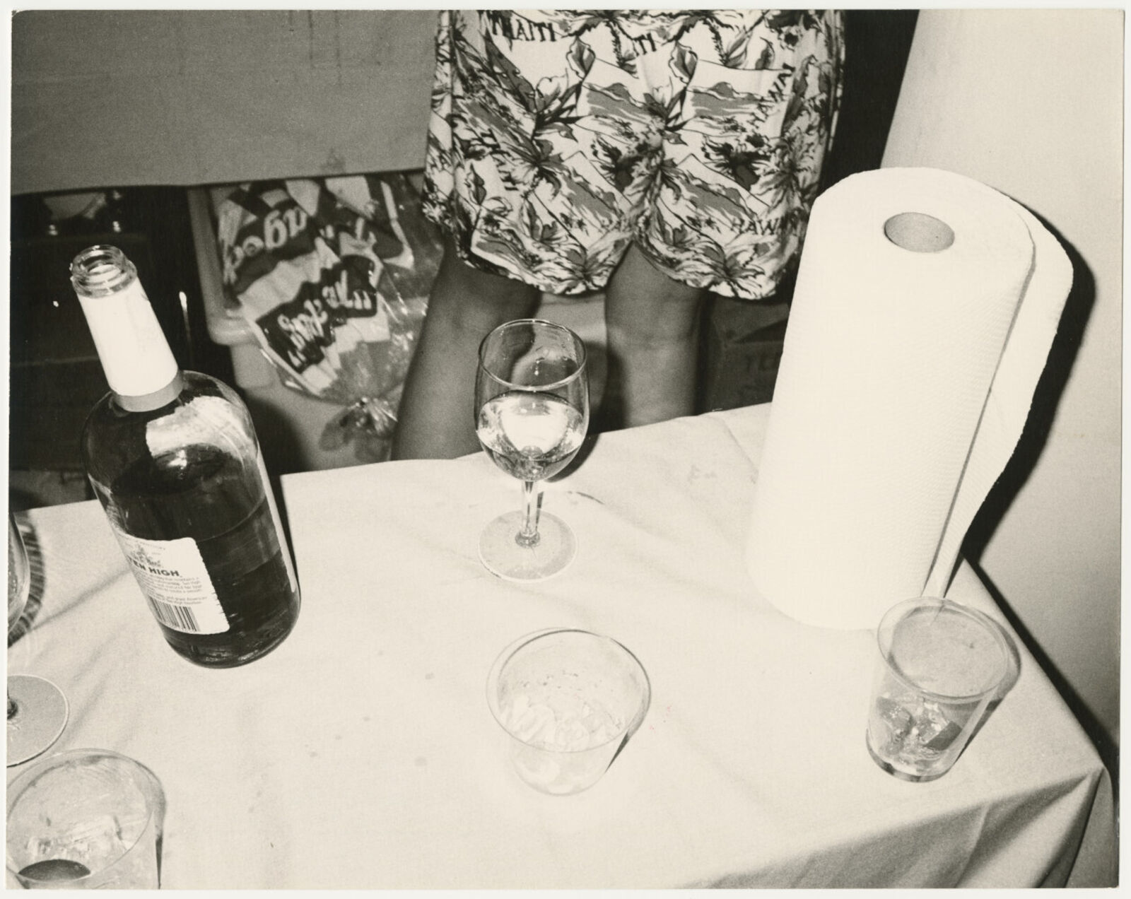 A table with a bottle of wine and a glass of water.
