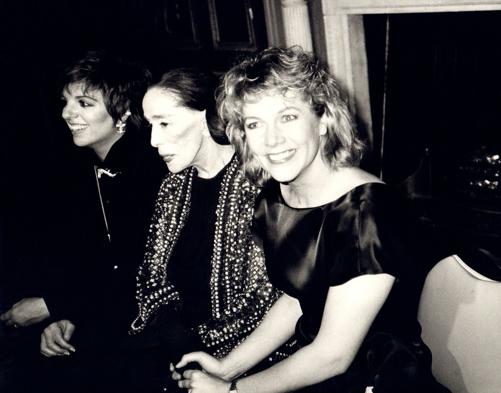 A group of three women sitting next to each other.