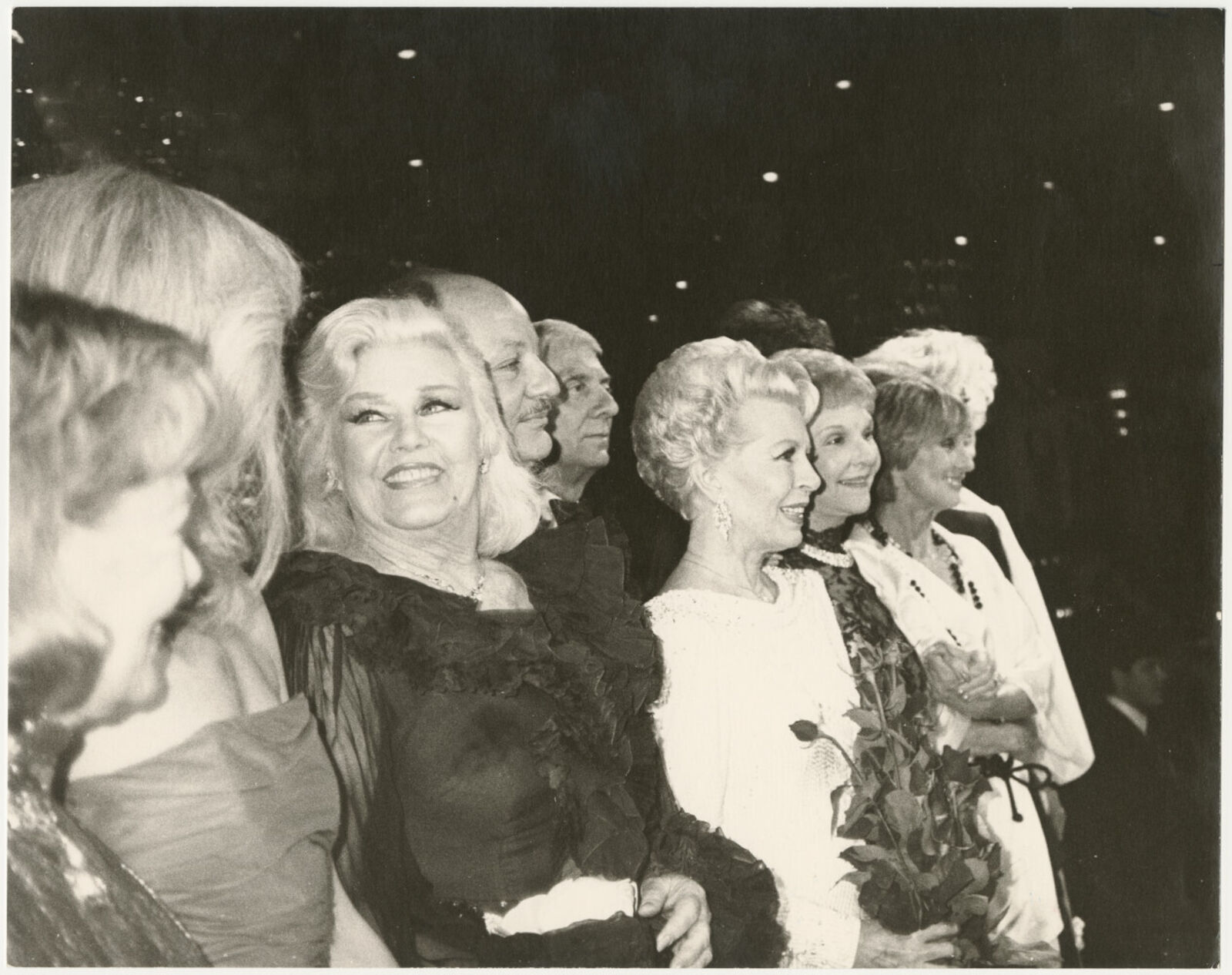 A group of women standing next to each other in a crowd.