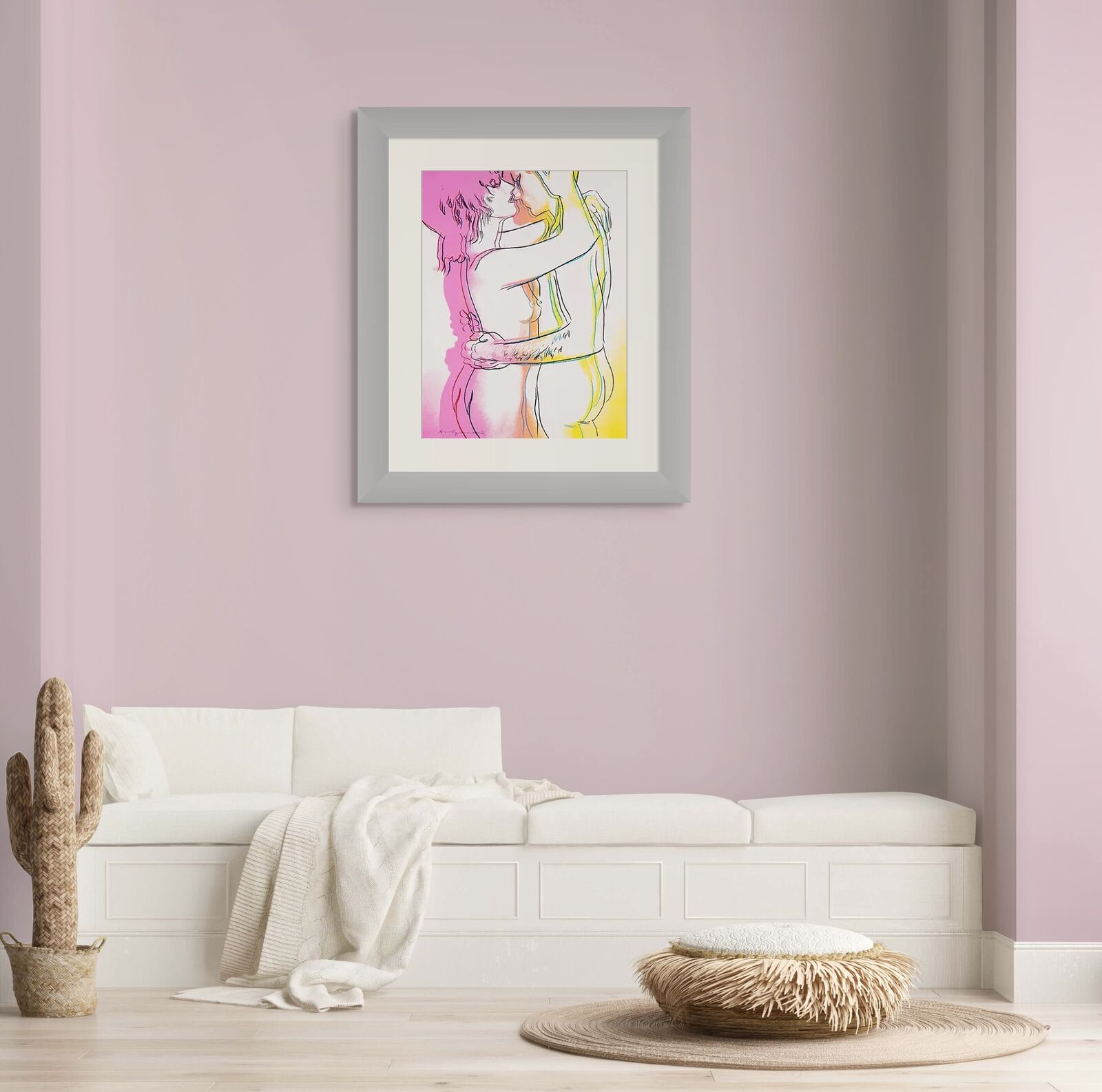 A bedroom with a bed and three framed pictures on the wall.