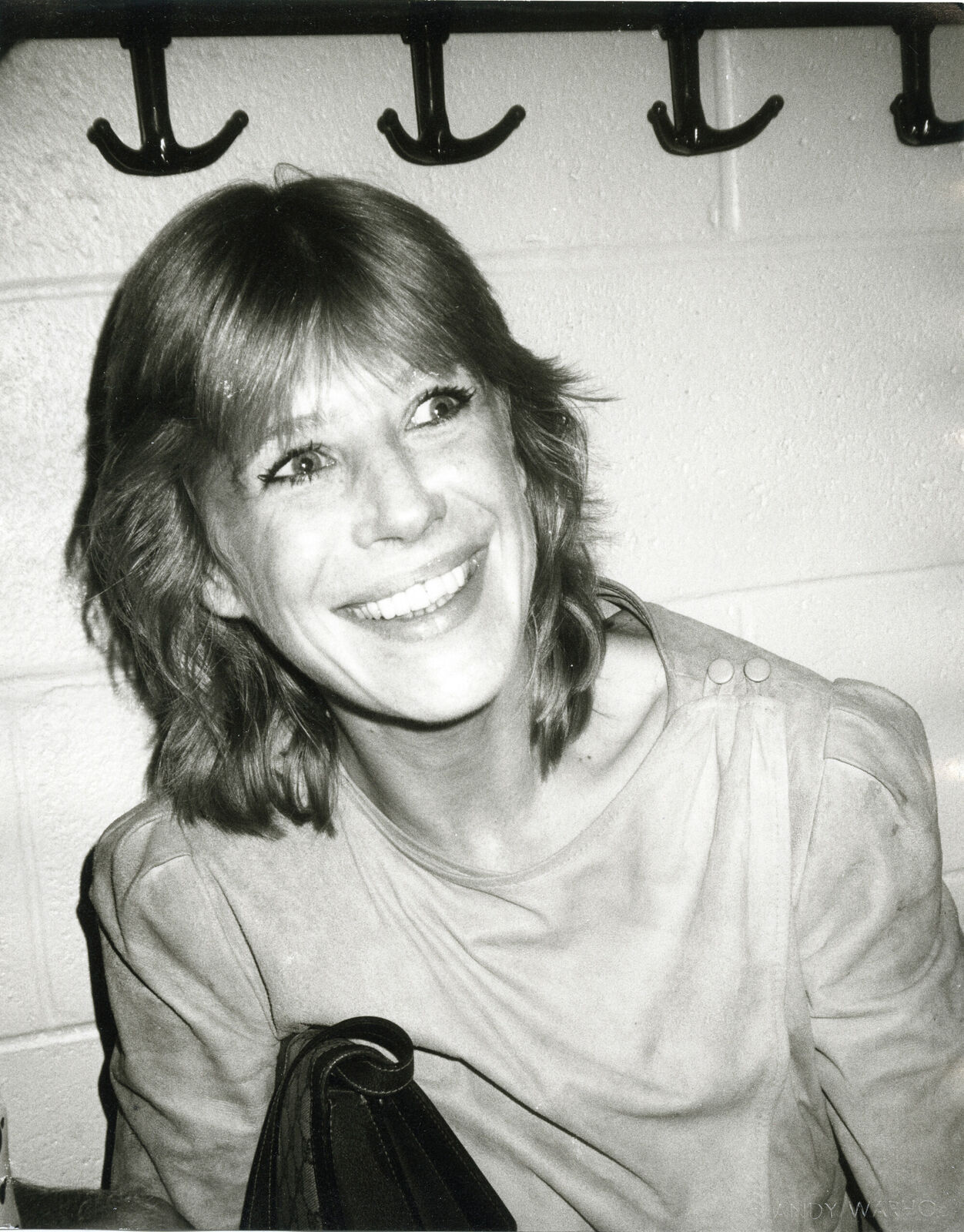 A black and white photo of a woman smiling.